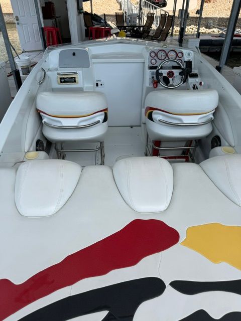 The image shows the cockpit of a 2002 Baja 25 Outlaw with two seats and a steering wheel.