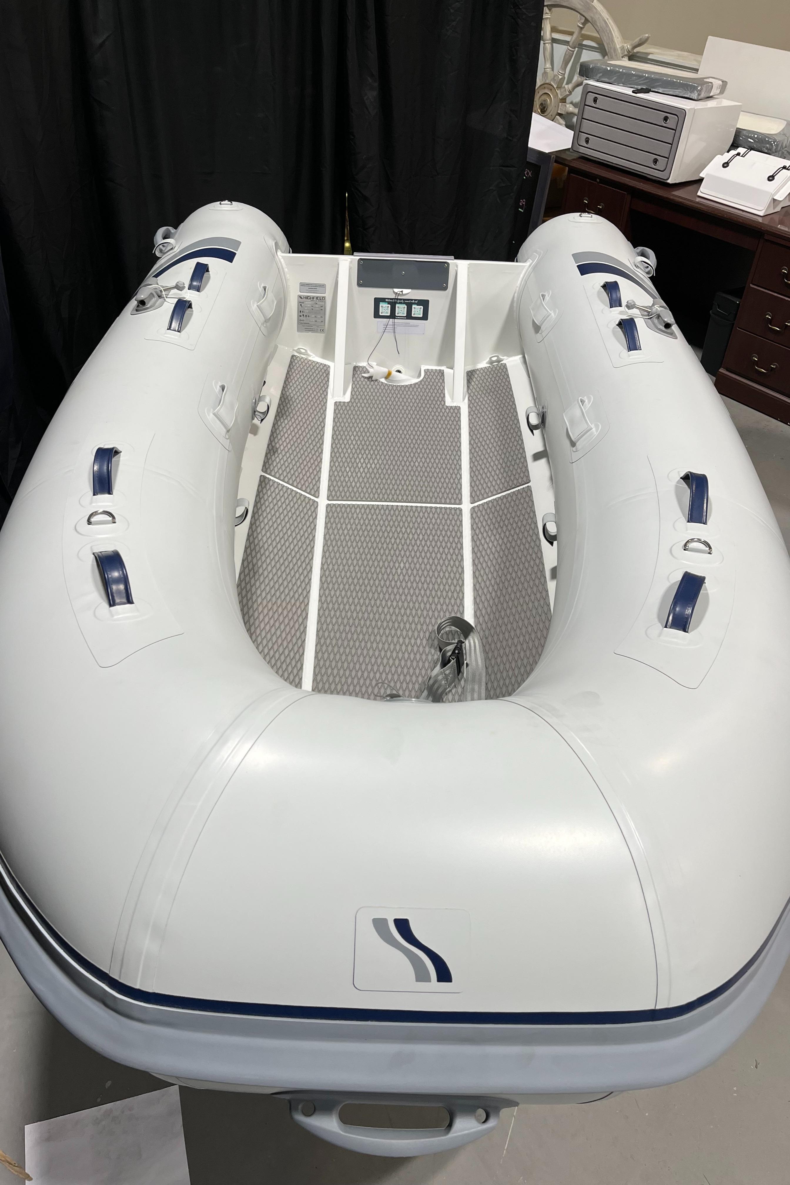 2025 Highfield Ultralite 310 inflatable boat, white, displayed indoors.
