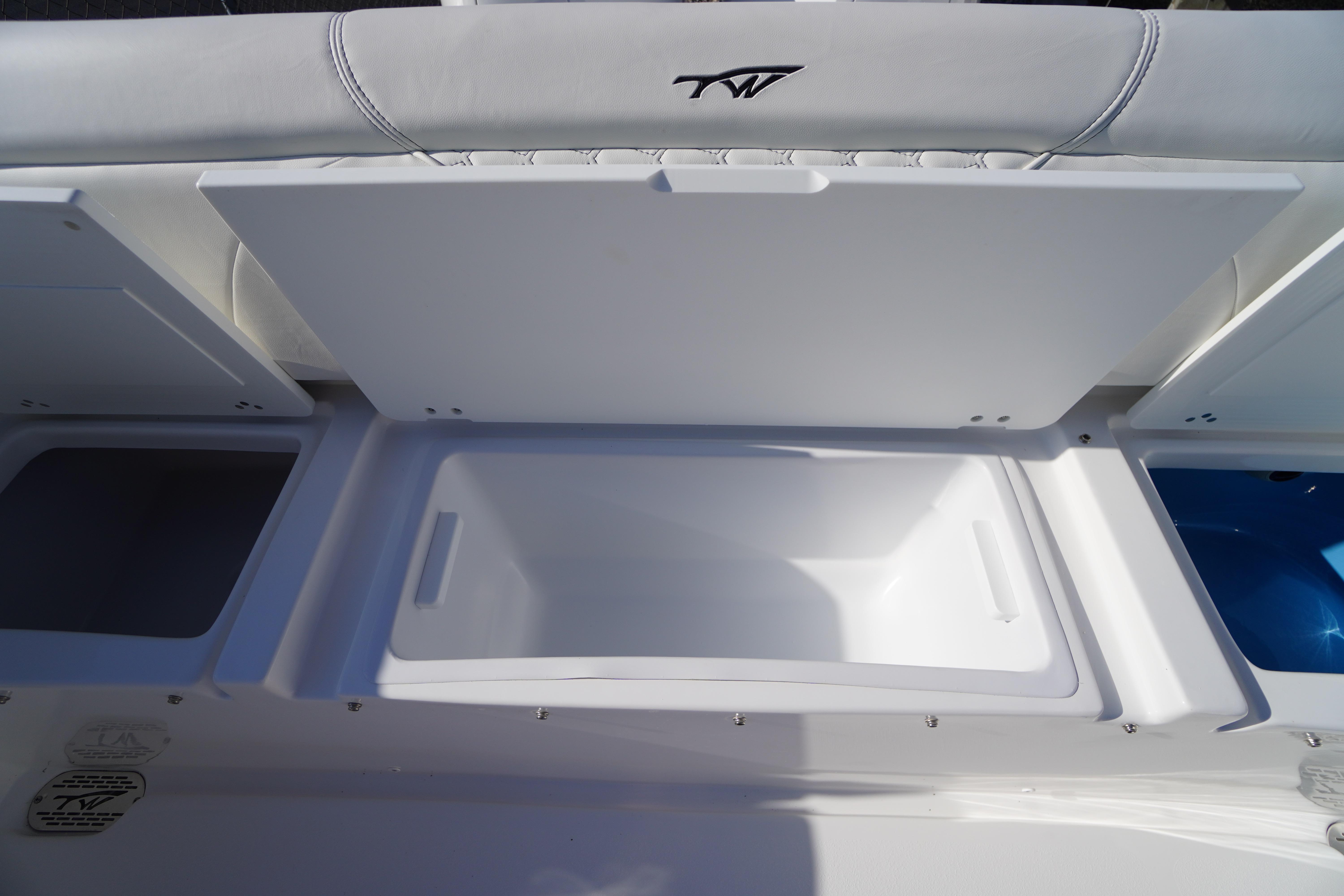 2026 Tidewater 272 LXF boat storage compartments with open lids, showcasing interior space.