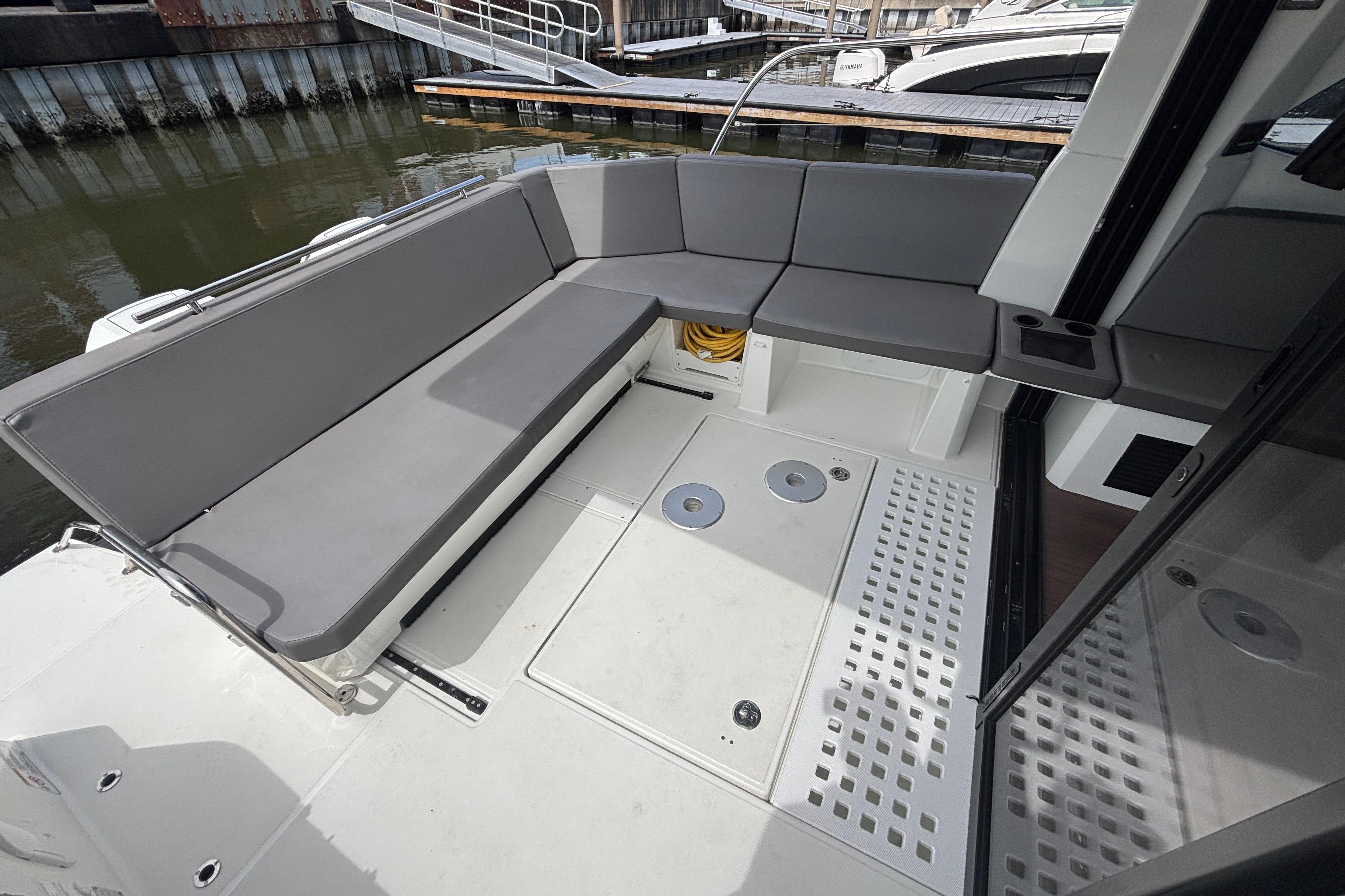 2024 Beneteau Antares 11 boat interior with gray seating and modern design.