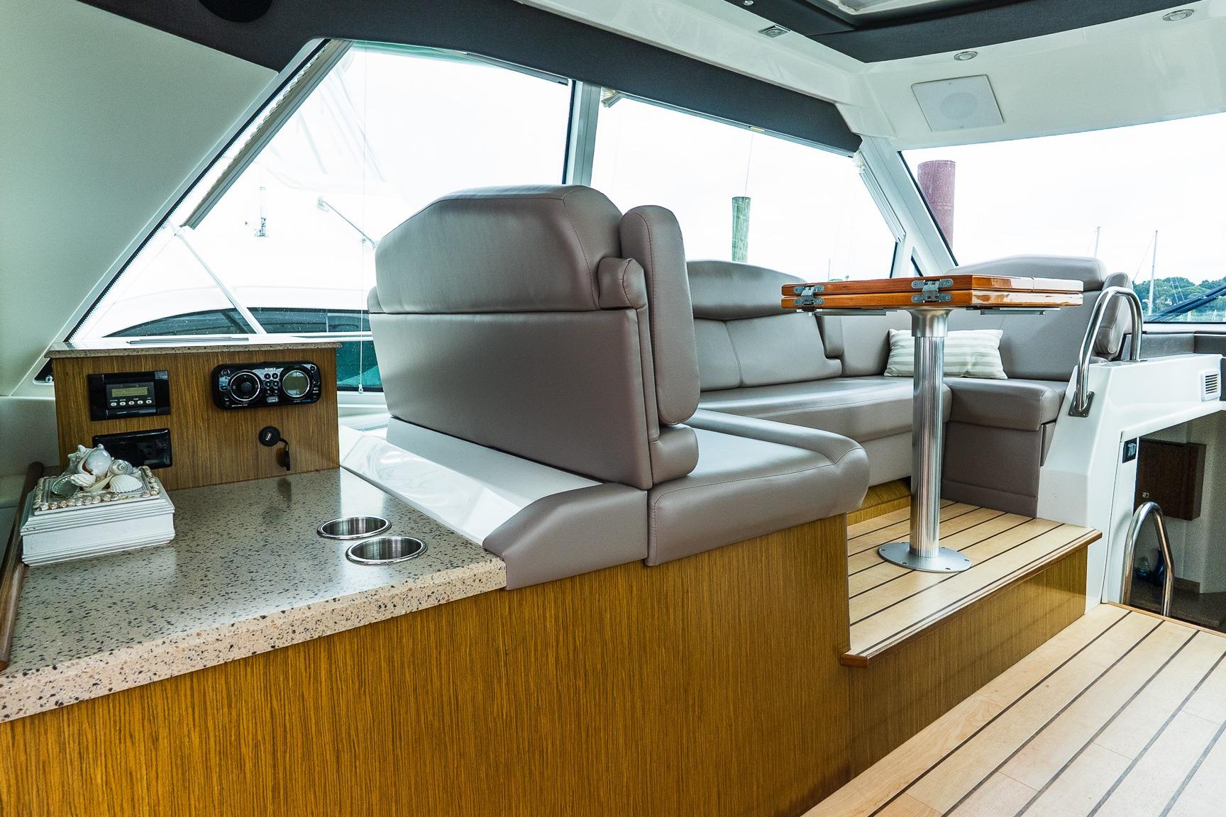 Luxurious interior of 2013 Cruisers Yachts 48 Cantius with plush seating and elegant table.