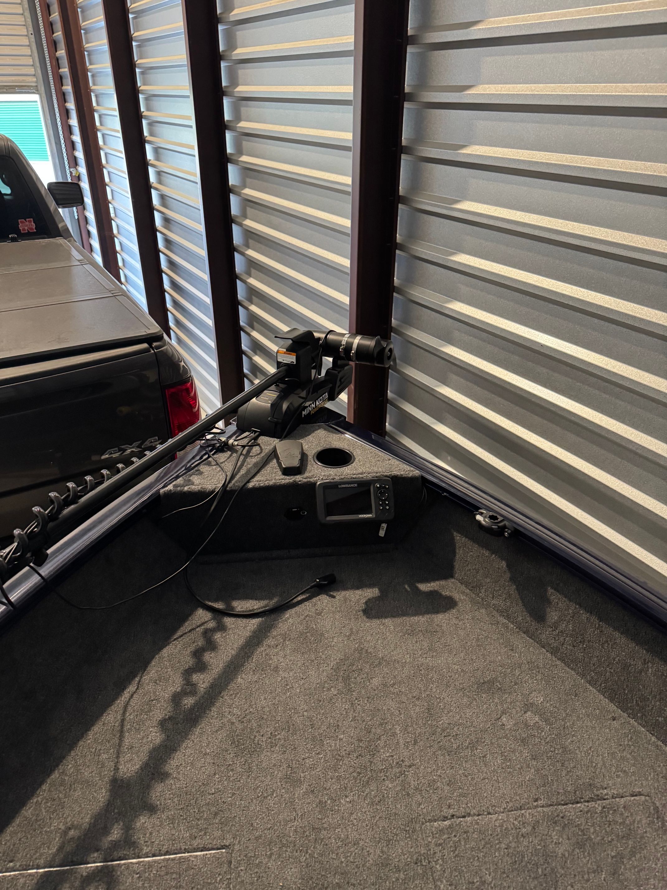 Bow of a Tracker Pro Guide V-16 SC with rod holder and electronics.