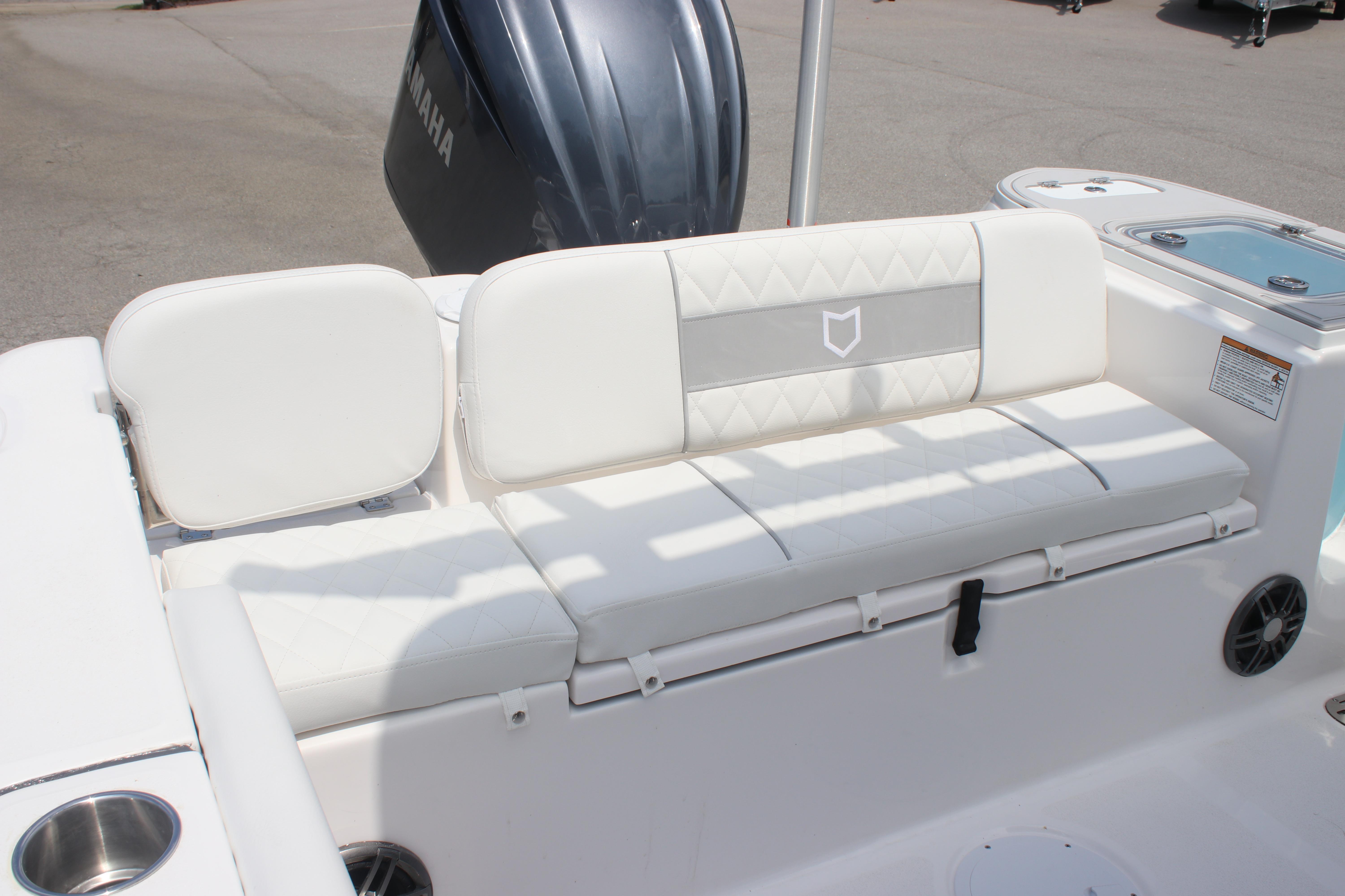 2026 Sea Fox 248 Commander boat with white cushioned seating and Yamaha engine.