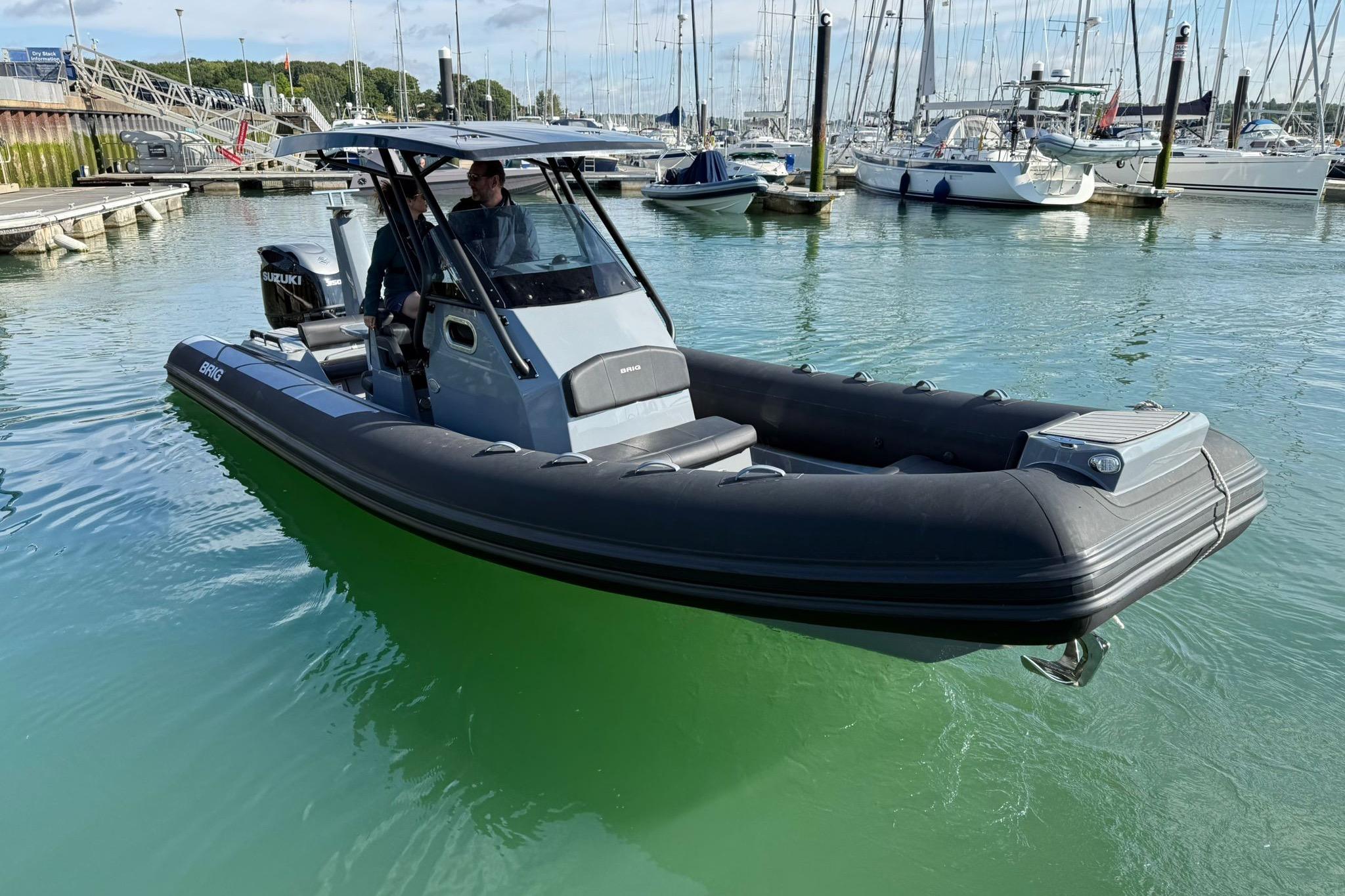 2023 Brig Eagle 8 boat in marina, featuring sleek design and Suzuki engine.