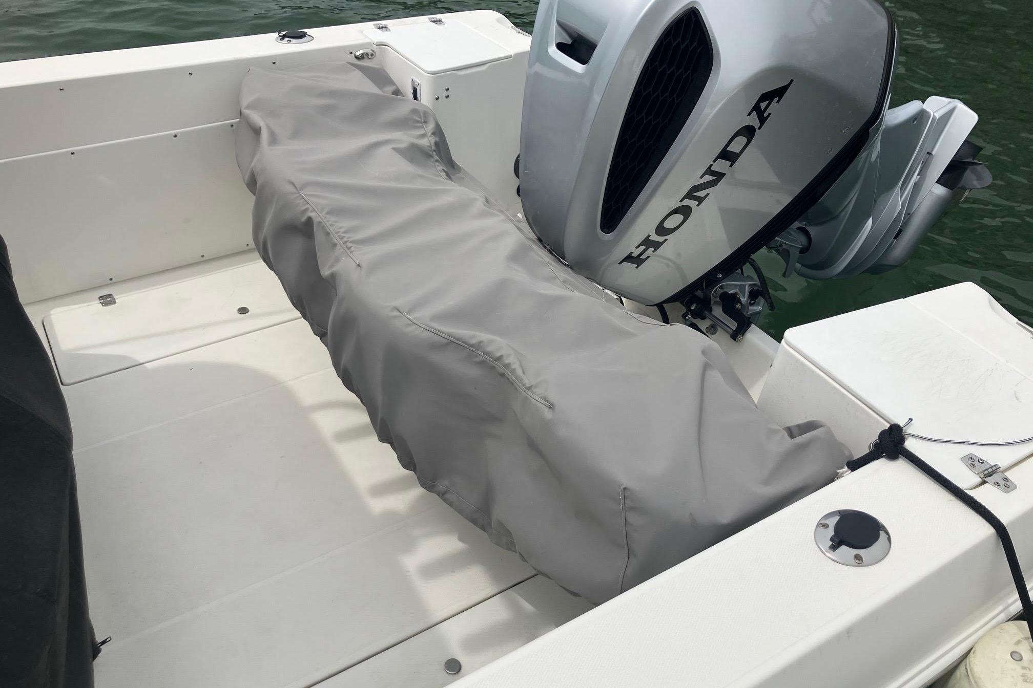 2002 Wellcraft 24 Walkaround boat with Honda outboard motor, covered seating area.