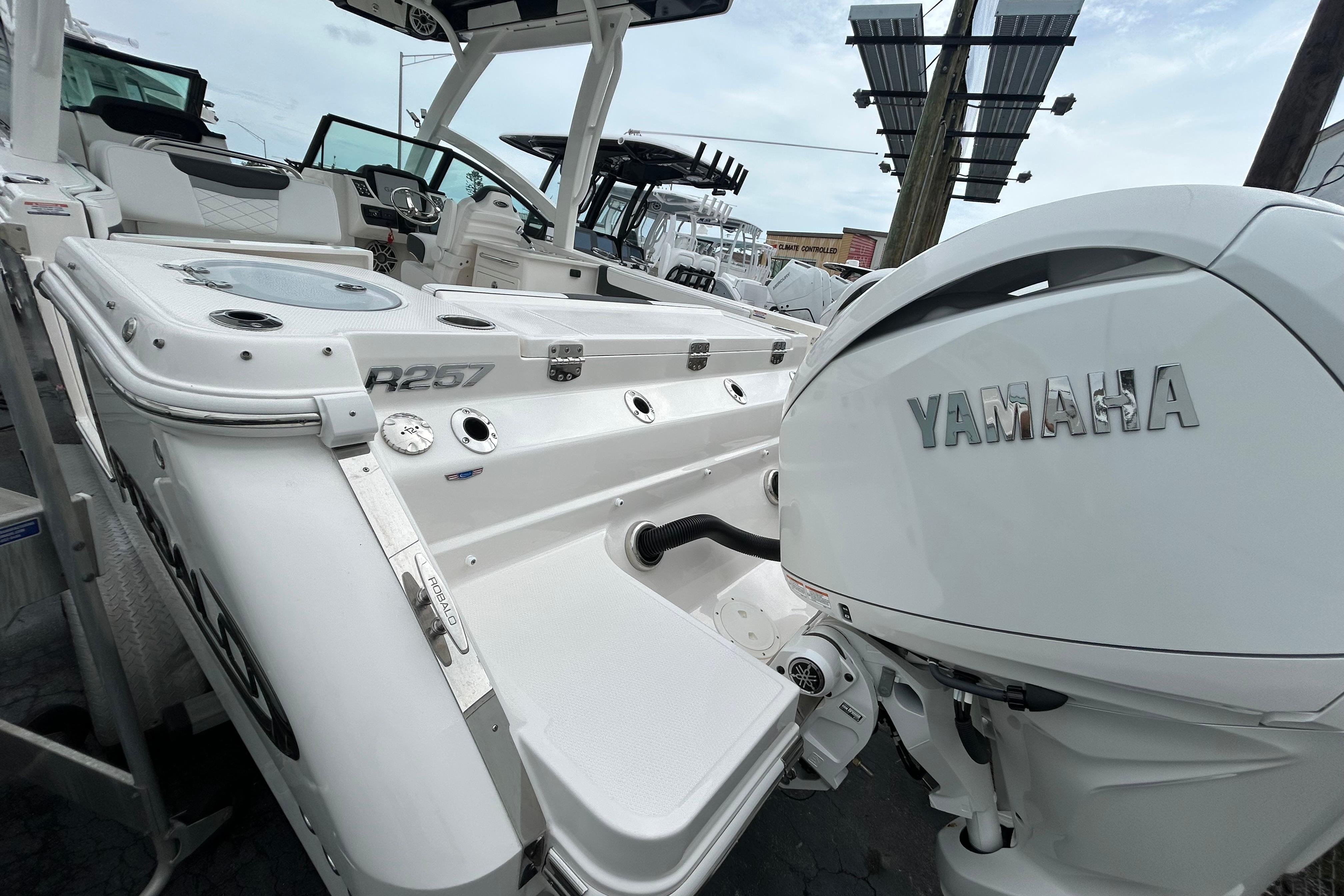 2026 Robalo R257 Dual Console boat with Yamaha engine, docked outdoors.