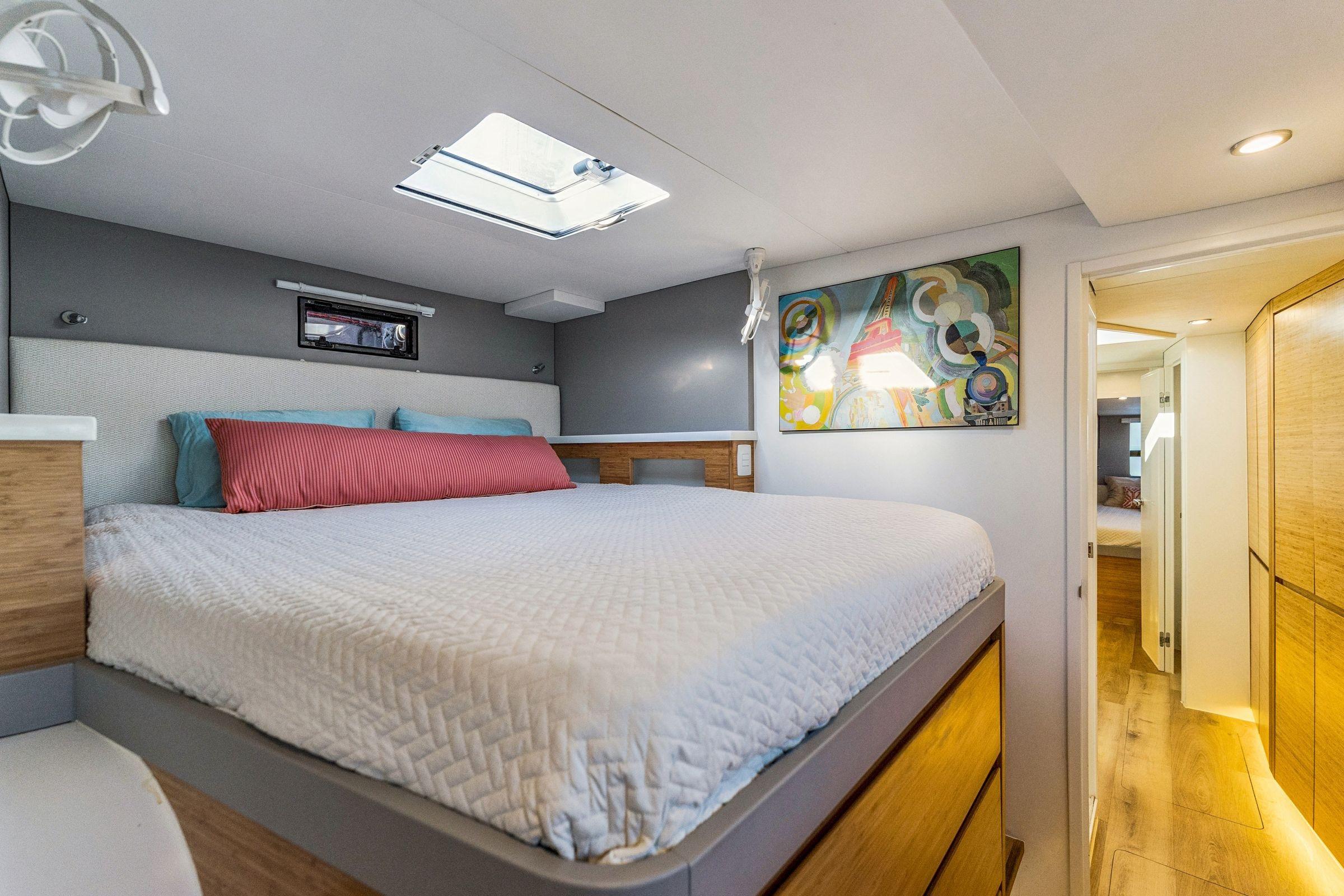 Luxurious bedroom interior in 2024 Balance 482 yacht with modern decor and skylight.