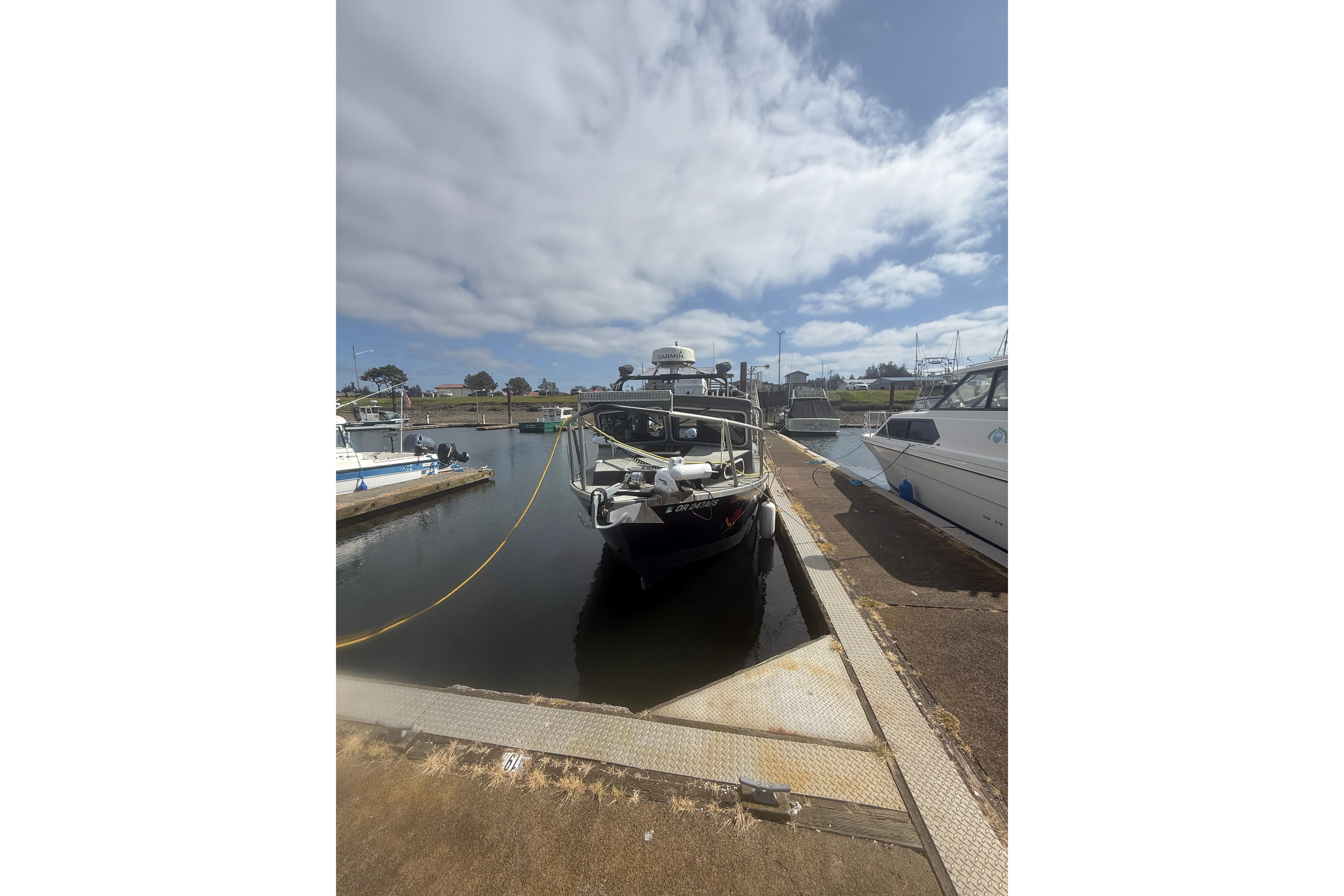2016 North River 29 Offshore boat docked at a marina under cloudy skies.