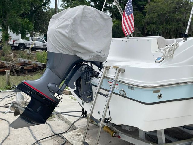 A 2018 Hurricane SS188 boat with a covered outboard motor and a ladder at the stern.