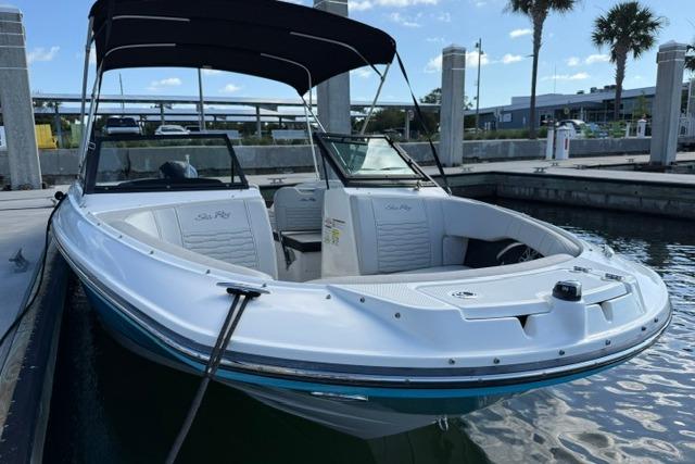 2022 Sea Ray SPX 210 Outboard boat docked at marina under clear sky.