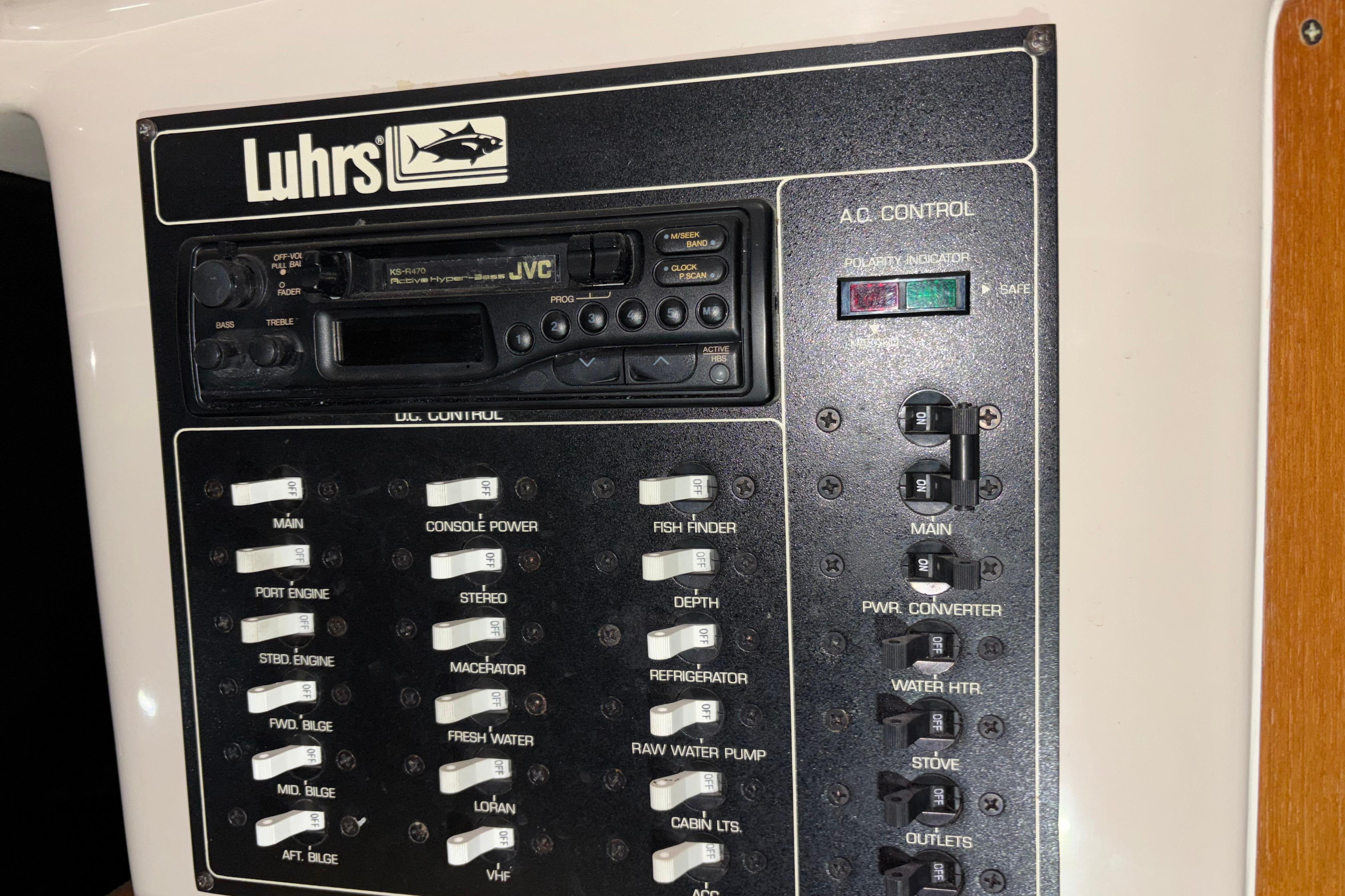 Control panel of a 1995 Luhrs 29 Open boat with switches and a JVC stereo.