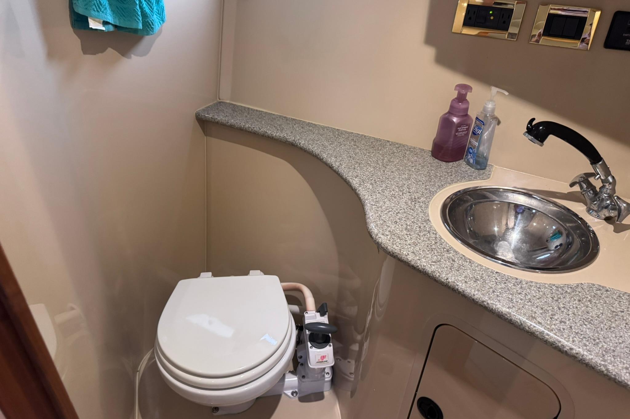 Bathroom interior of 2002 Cruisers Yachts 3275 Express with toilet and sink.