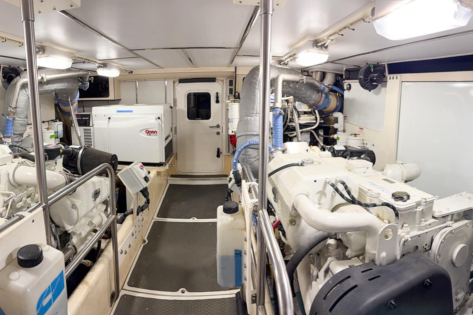 Engine room of a 2007 Nordic Tug 54, featuring Onan generator and dual engines.