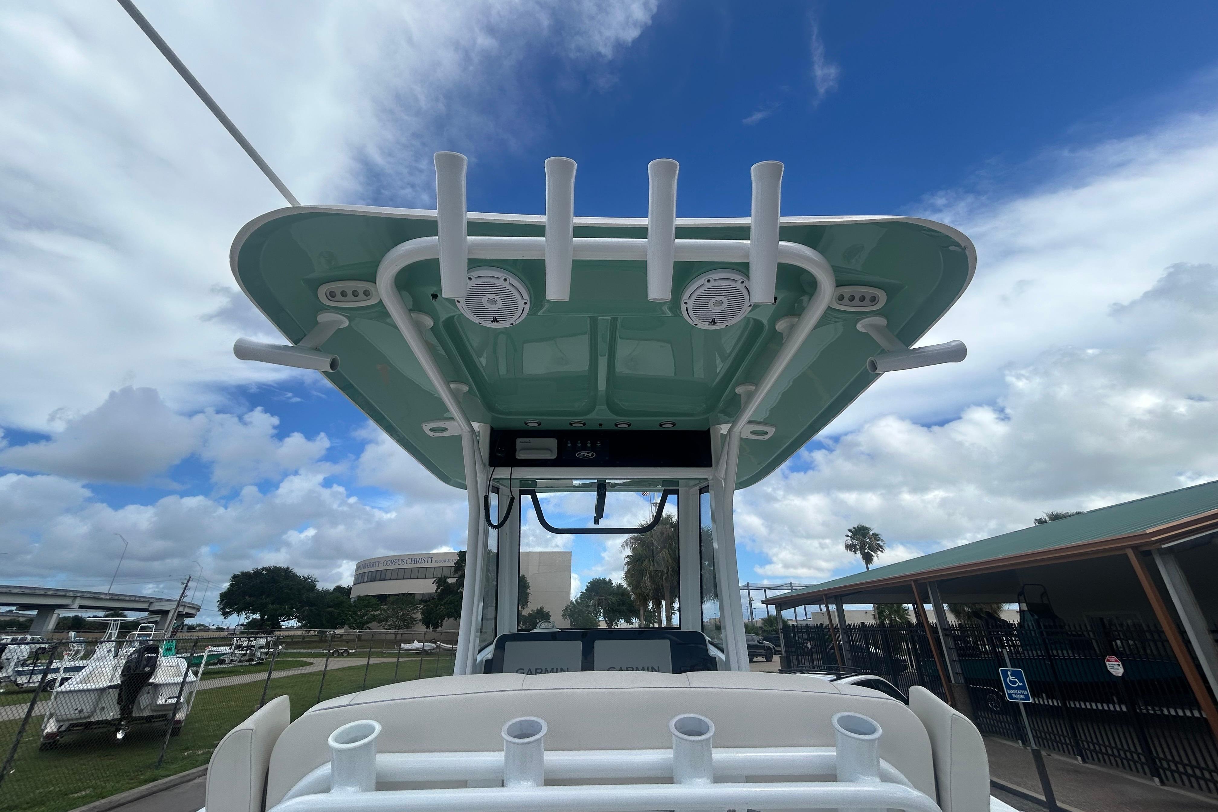 2023 Sea Hunt Gamefish 27 Coffin Box boat with rod holders and T-top under a blue sky.