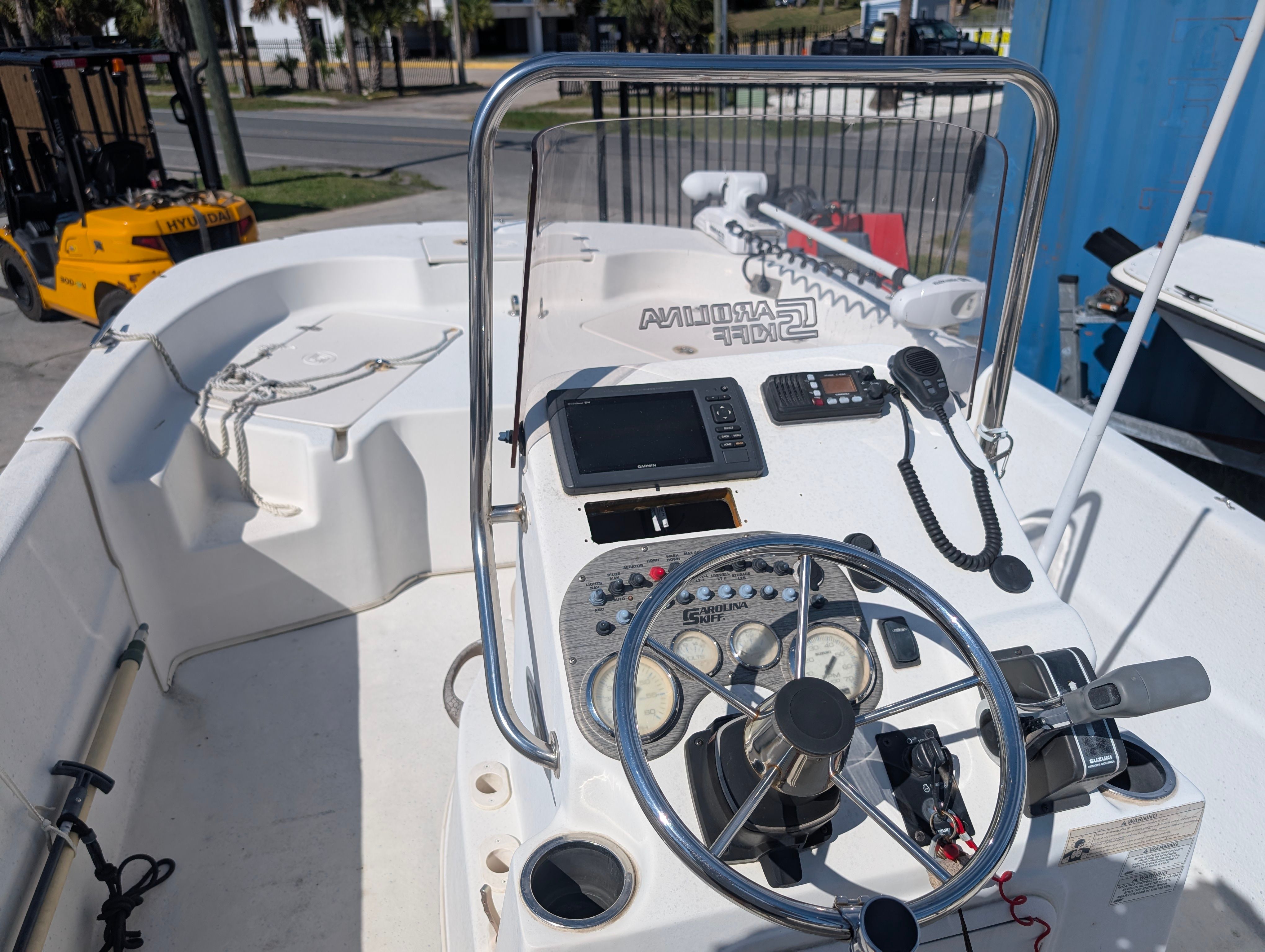 The image shows the helm of a 2016 Carolina Skiff 198 DLV with steering wheel and instruments.