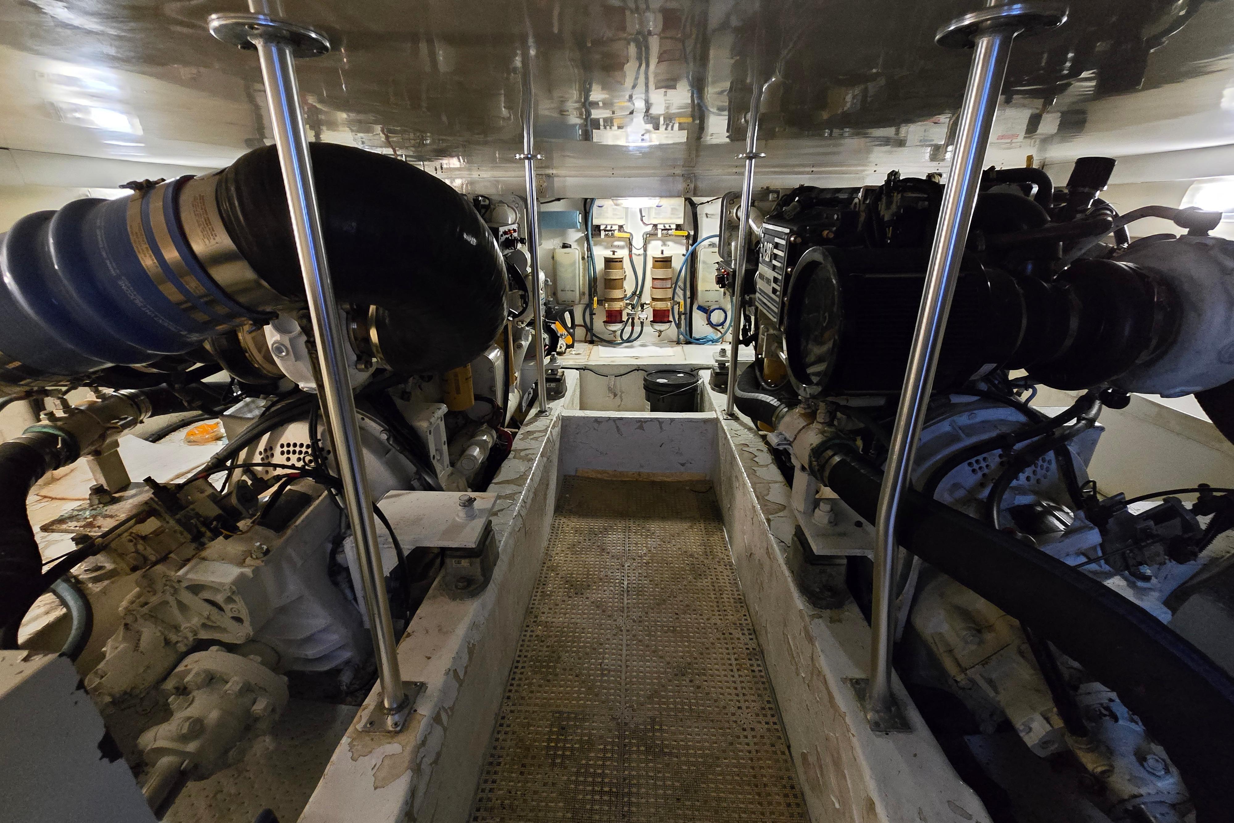 Engine room of a 2001 Cavileer 53 Convertible yacht, showcasing dual engines and mechanical components.
