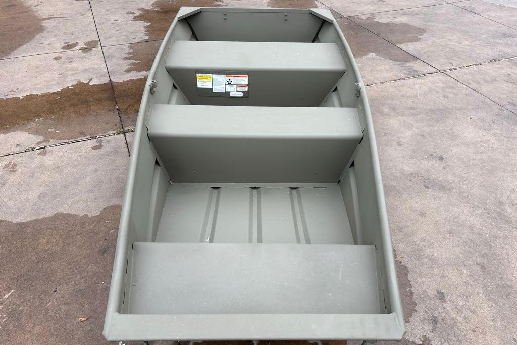 2026 Tracker Grizzly 10 Jon boat on concrete surface, showcasing interior seating and design.