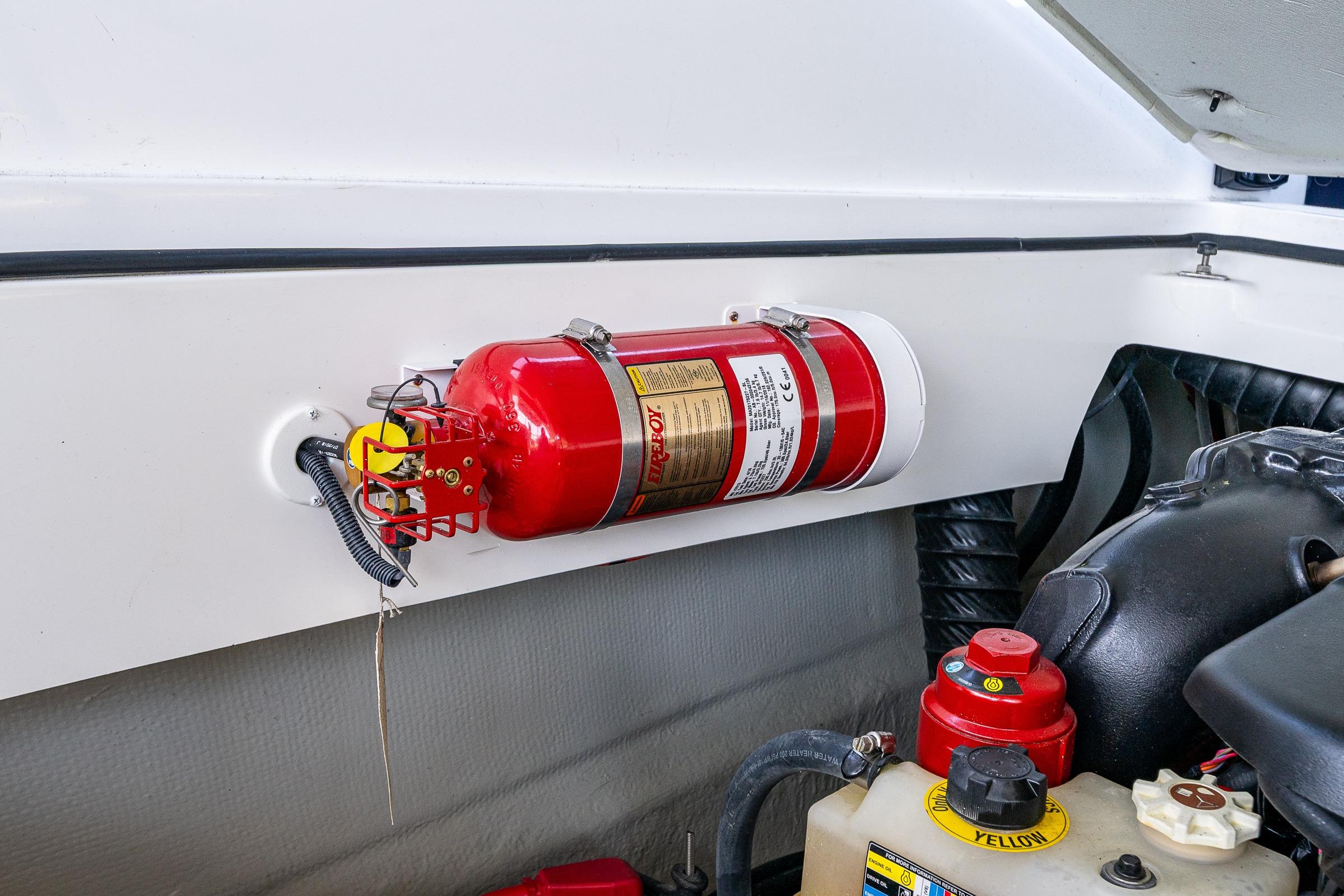Fire extinguisher mounted in 2019 Cobalt R30 boat engine compartment.