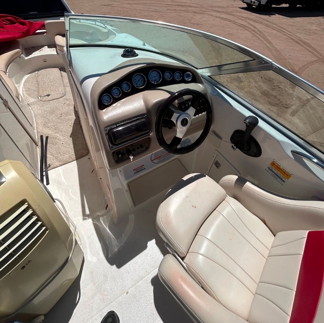 Interior of a 2001 Chaparral Sunesta 233 boat with steering console.