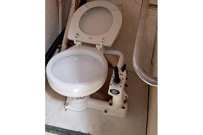Marine toilet in a 1980 Thompson Passenger and Dive Trawler bathroom.