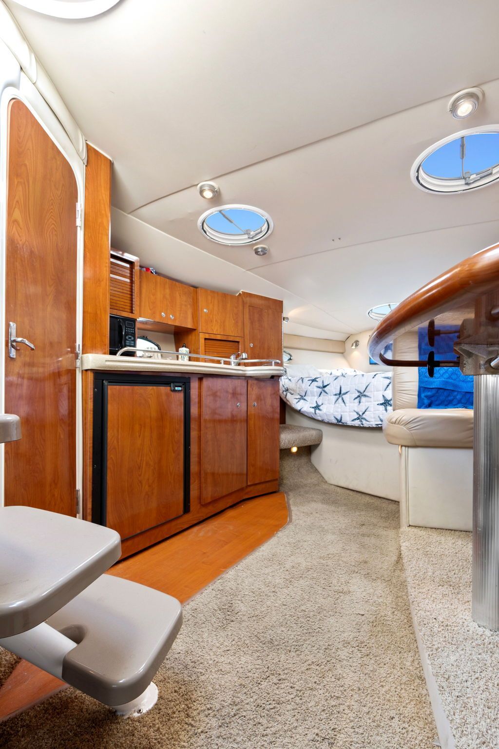 Interior of a 2007 Larson Cabrio 330 with kitchen, seating area, and sleeping space.