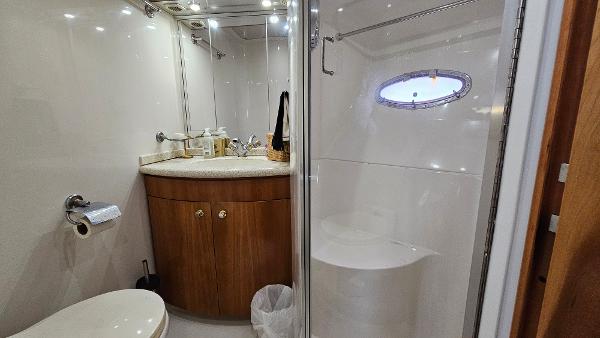 Bathroom interior of 2000 Carver 450 Voyager Pilothouse yacht, featuring shower and vanity.