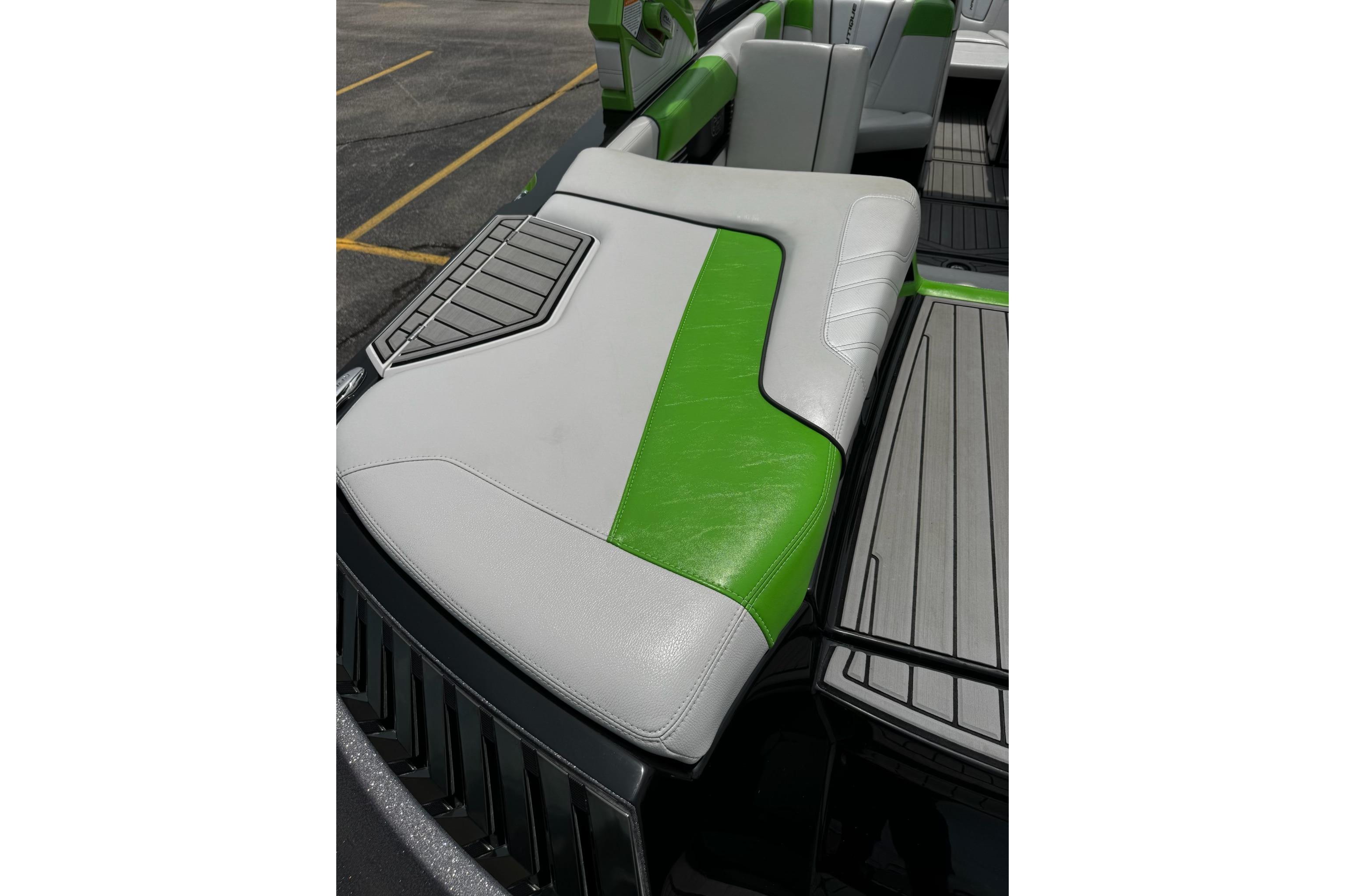 2014 Nautique Super Air Nautique G21 boat interior with green and gray seating.
