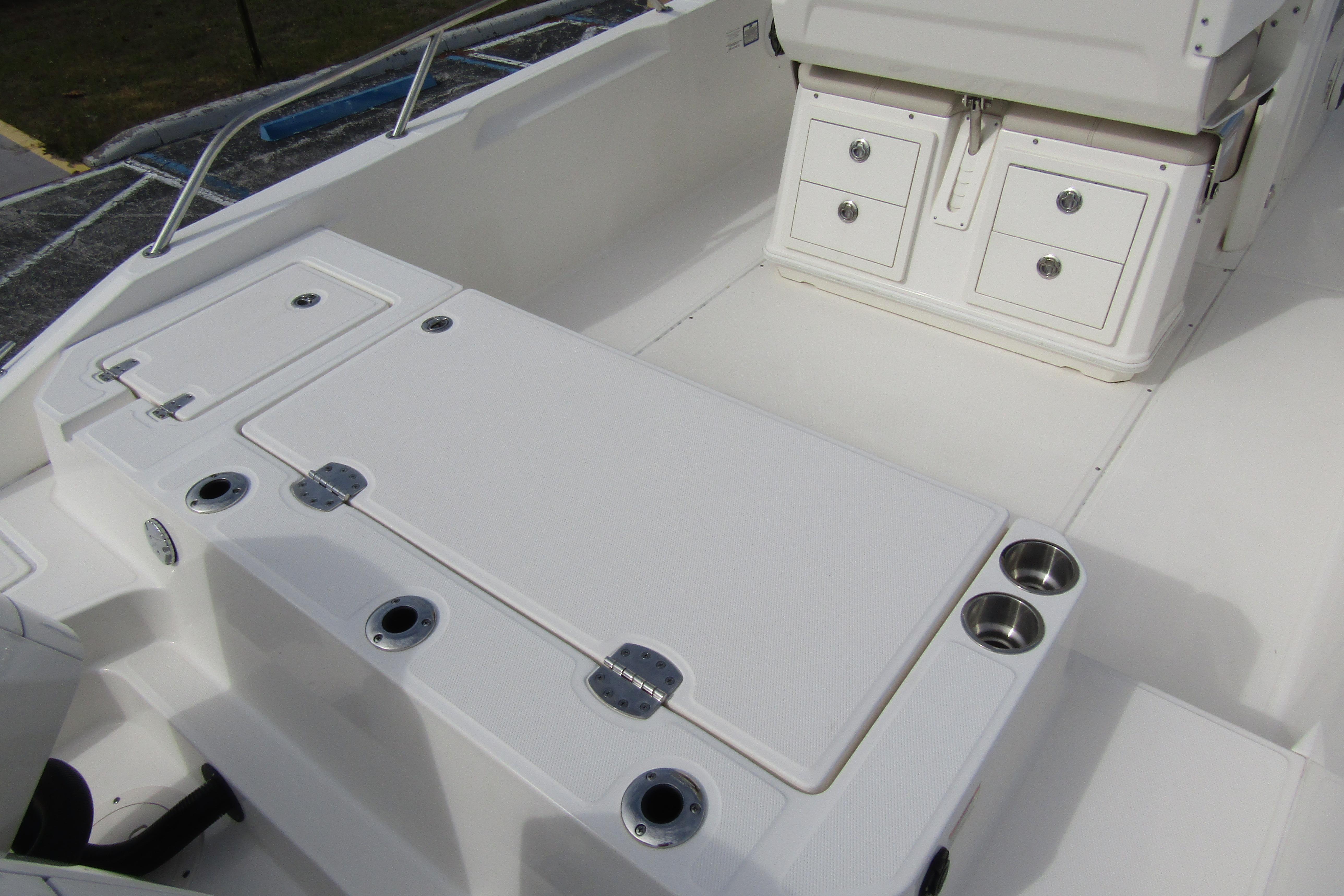 2023 Boston Whaler 280 Dauntless interior with storage compartments and cup holders.