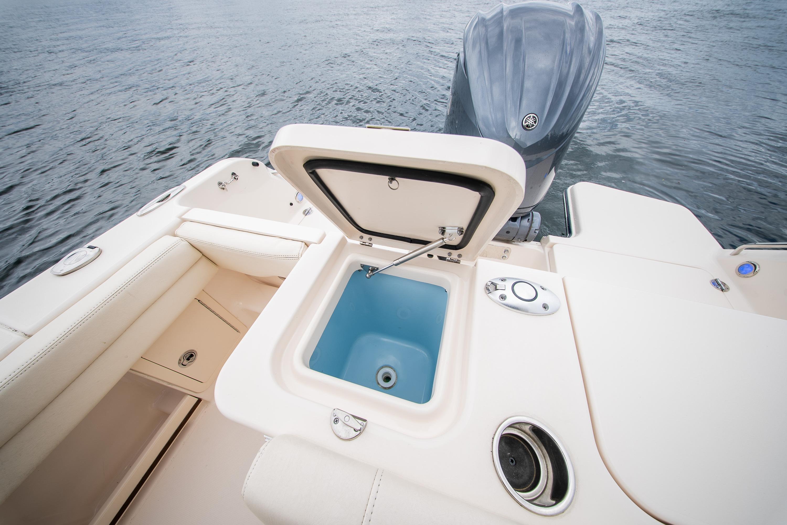 2023 Grady-White Freedom 235 boat with open storage compartment and Yamaha outboard motor.