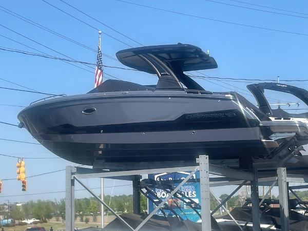 2025 Chaparral 2870 boat displayed on a rack with an American flag in the background.