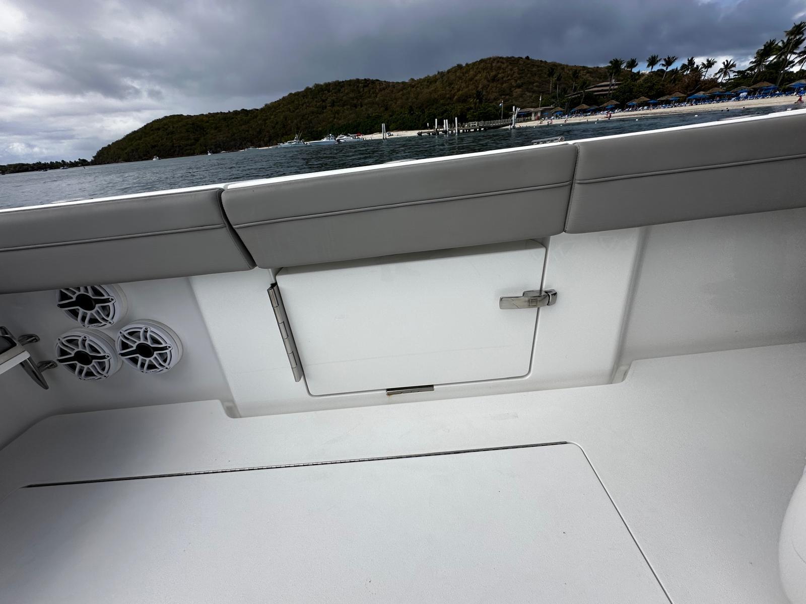 2023 Valhalla Boatworks V-46 interior with speakers, storage, and ocean view.