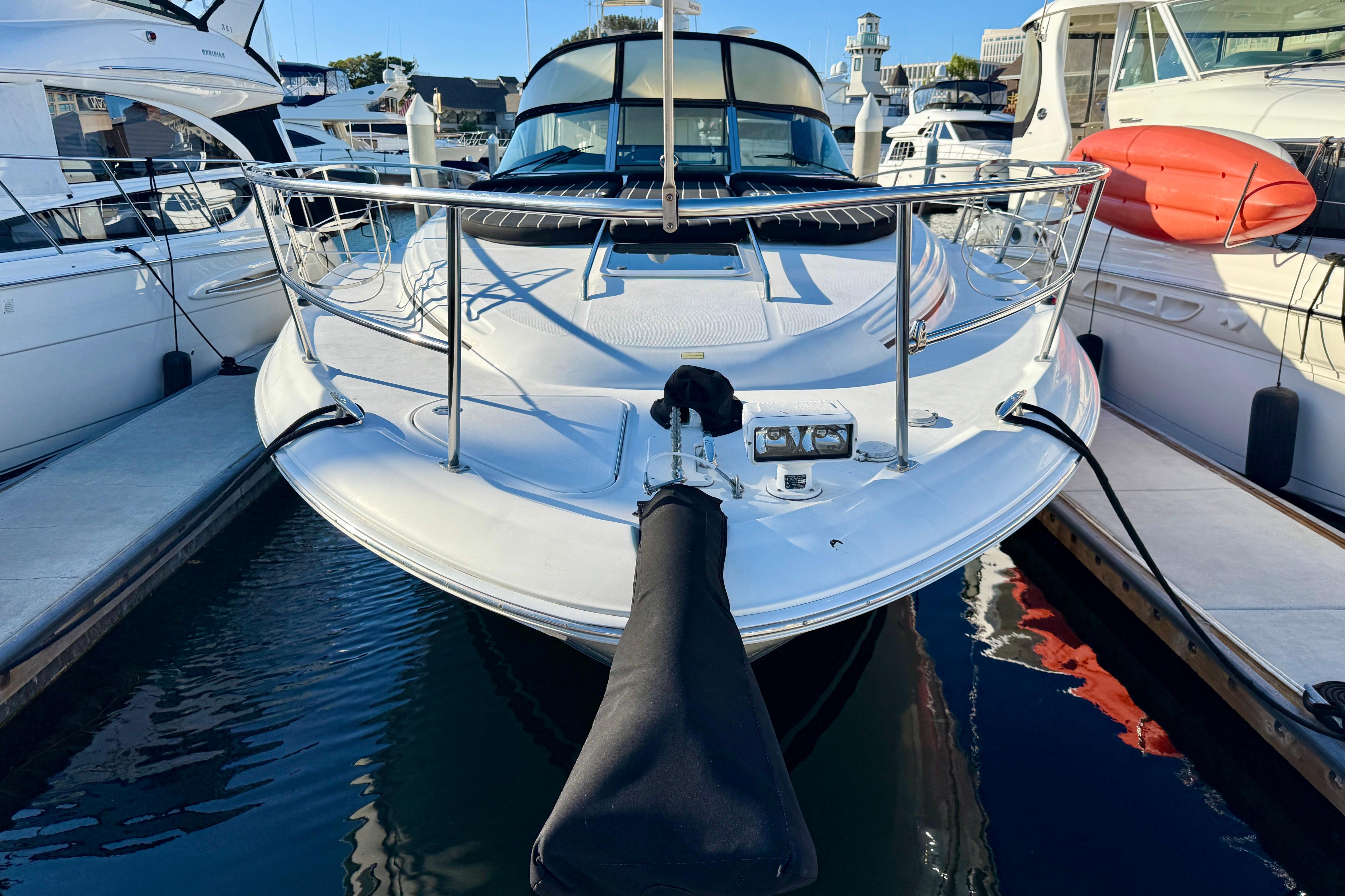2003 Sea Ray 380 Sundancer yacht docked at marina, front view.