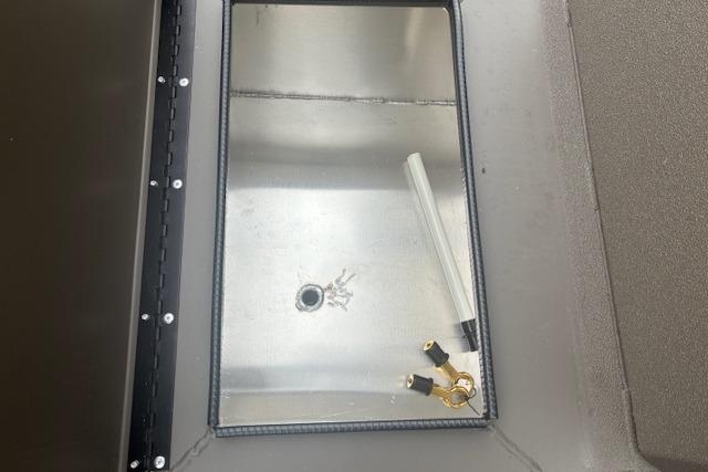 Alweld 1760VV Marsh Console CC 2026 boat compartment with keys and a tube inside.