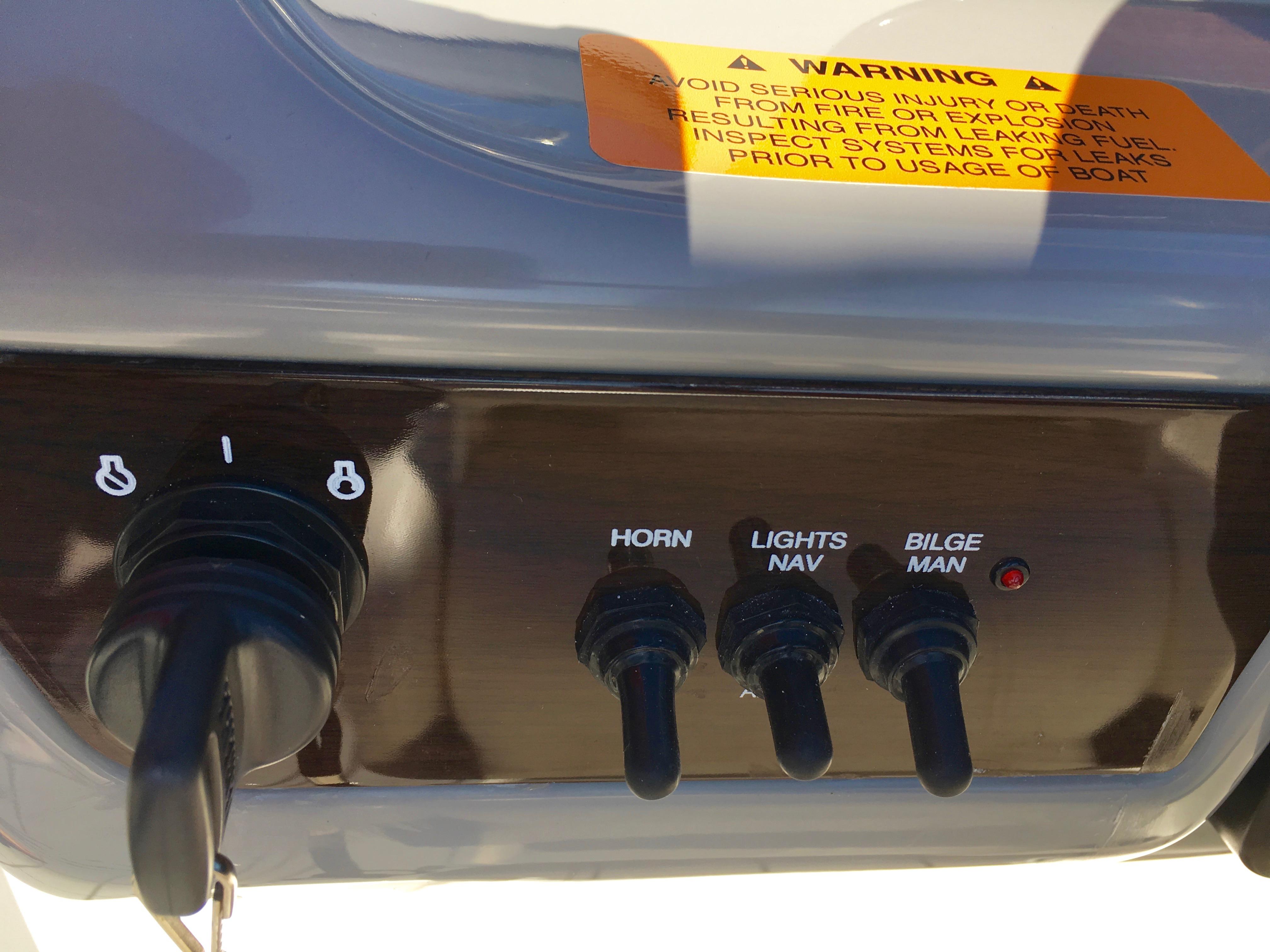 Control panel of a 2022 Chaparral 230 SSi with switches for horn, lights, and bilge.