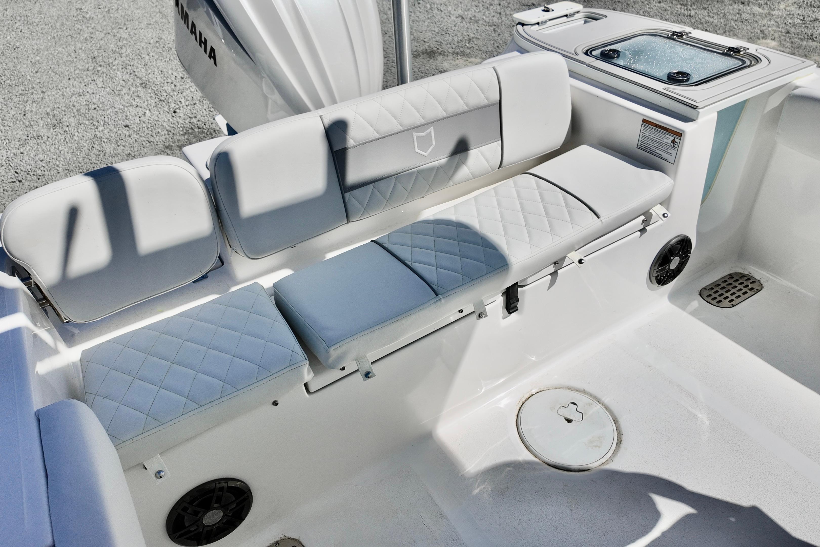 2026 Sea Fox 248 Commander boat interior with cushioned seating and Yamaha engine.