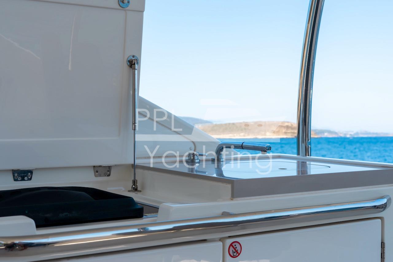 Outdoor kitchen area on 2021 Absolute 47 Fly yacht with ocean view.