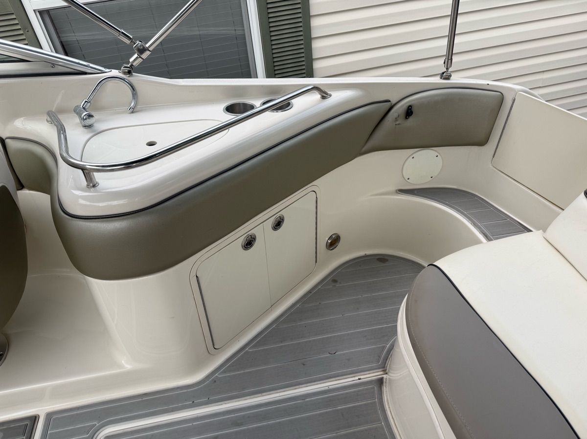 The image shows the cockpit of a 2007 Sea Ray 240 Sundeck with sleek seating and a sink.