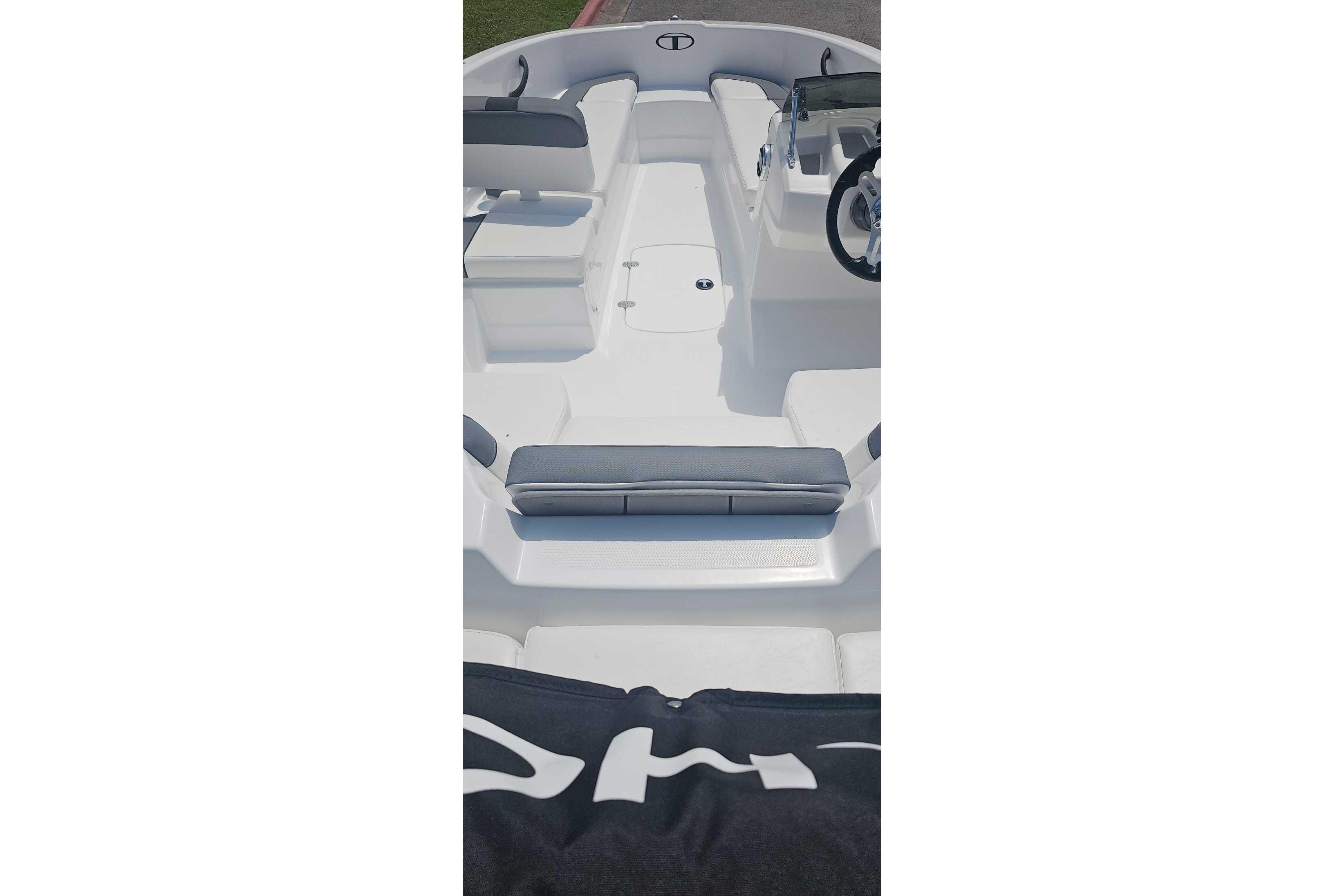 2026 Tahoe T16 boat interior with sleek white seating and modern steering console.
