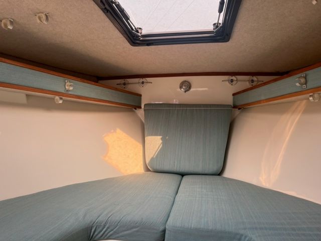 Interior of a 2002 Carolina Classic 25 boat with blue upholstery.