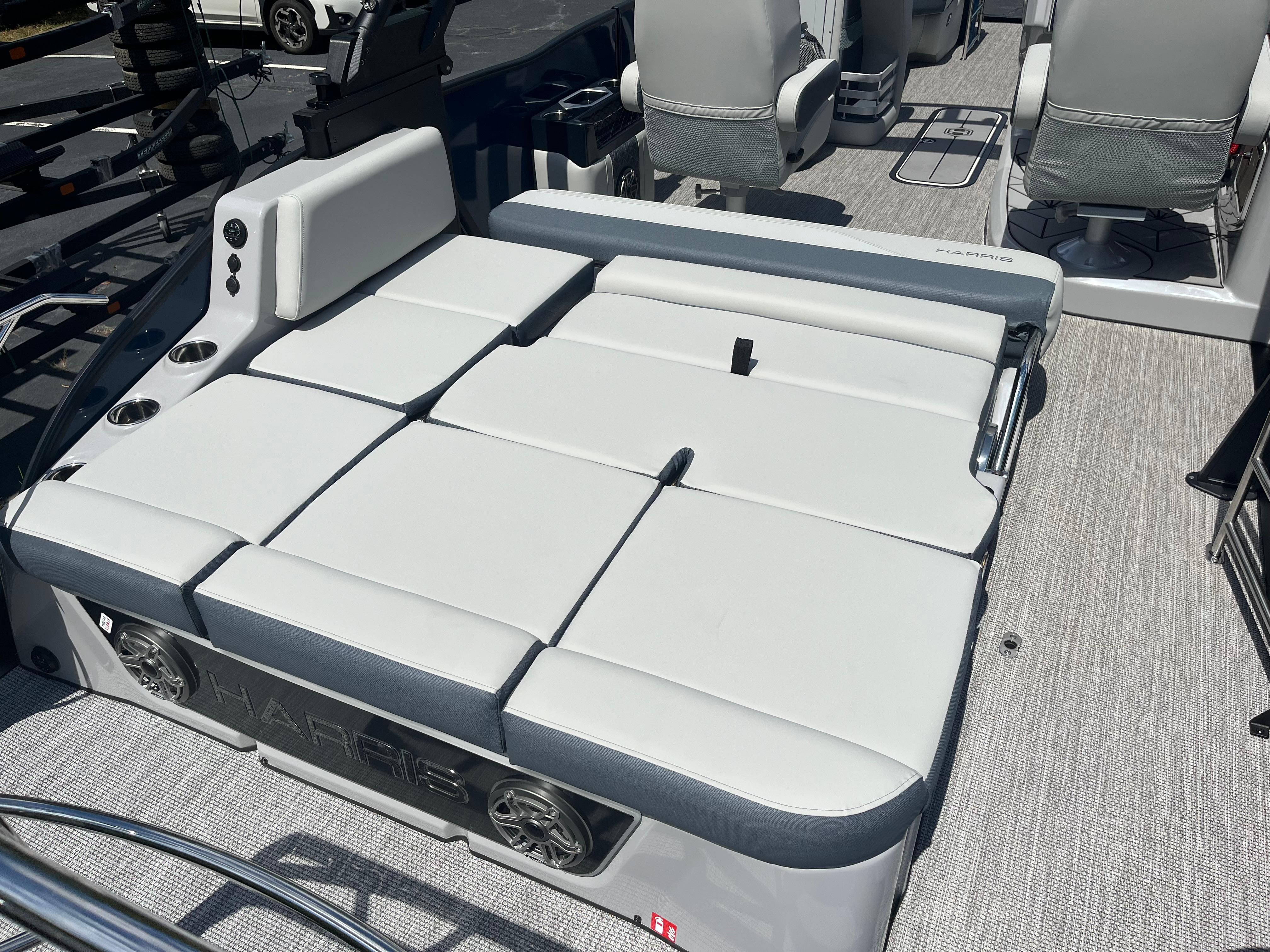 2026 Harris Grand Mariner 230 boat interior with plush seating and cup holders.