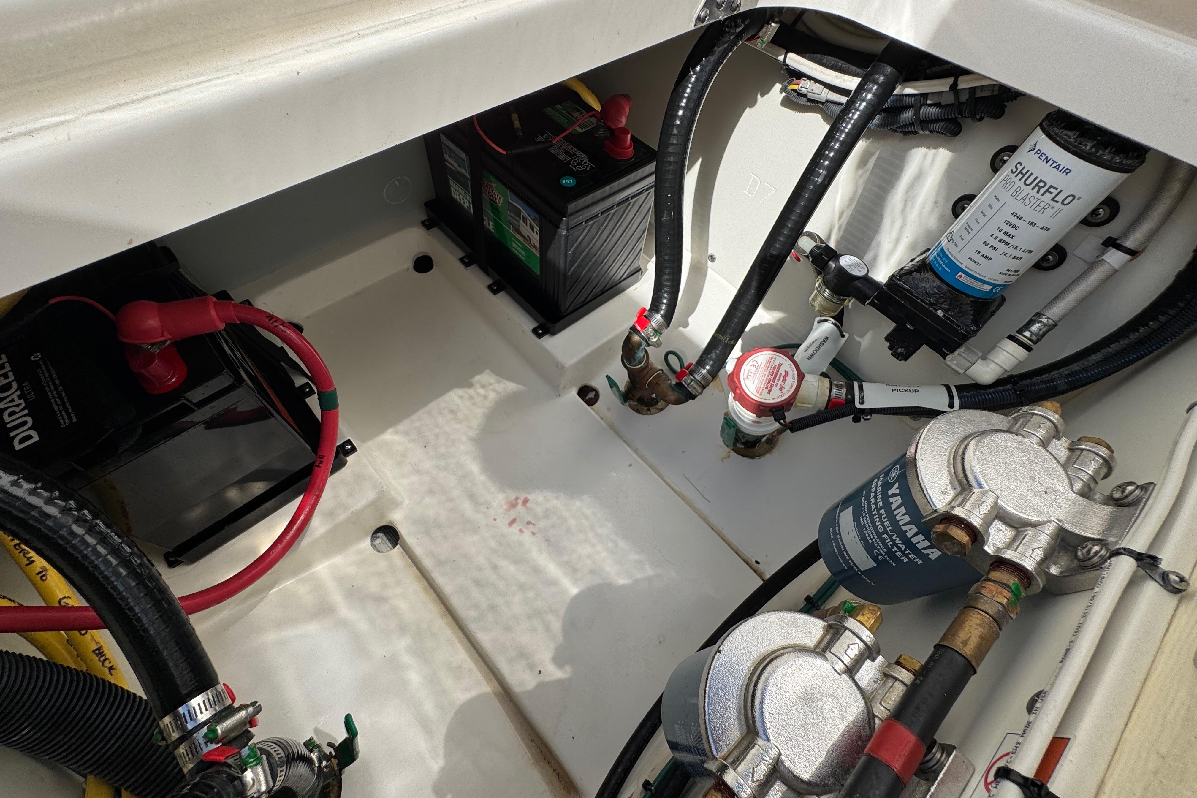 2022 Pursuit DC 266 Dual Console engine compartment with batteries and fuel filters.