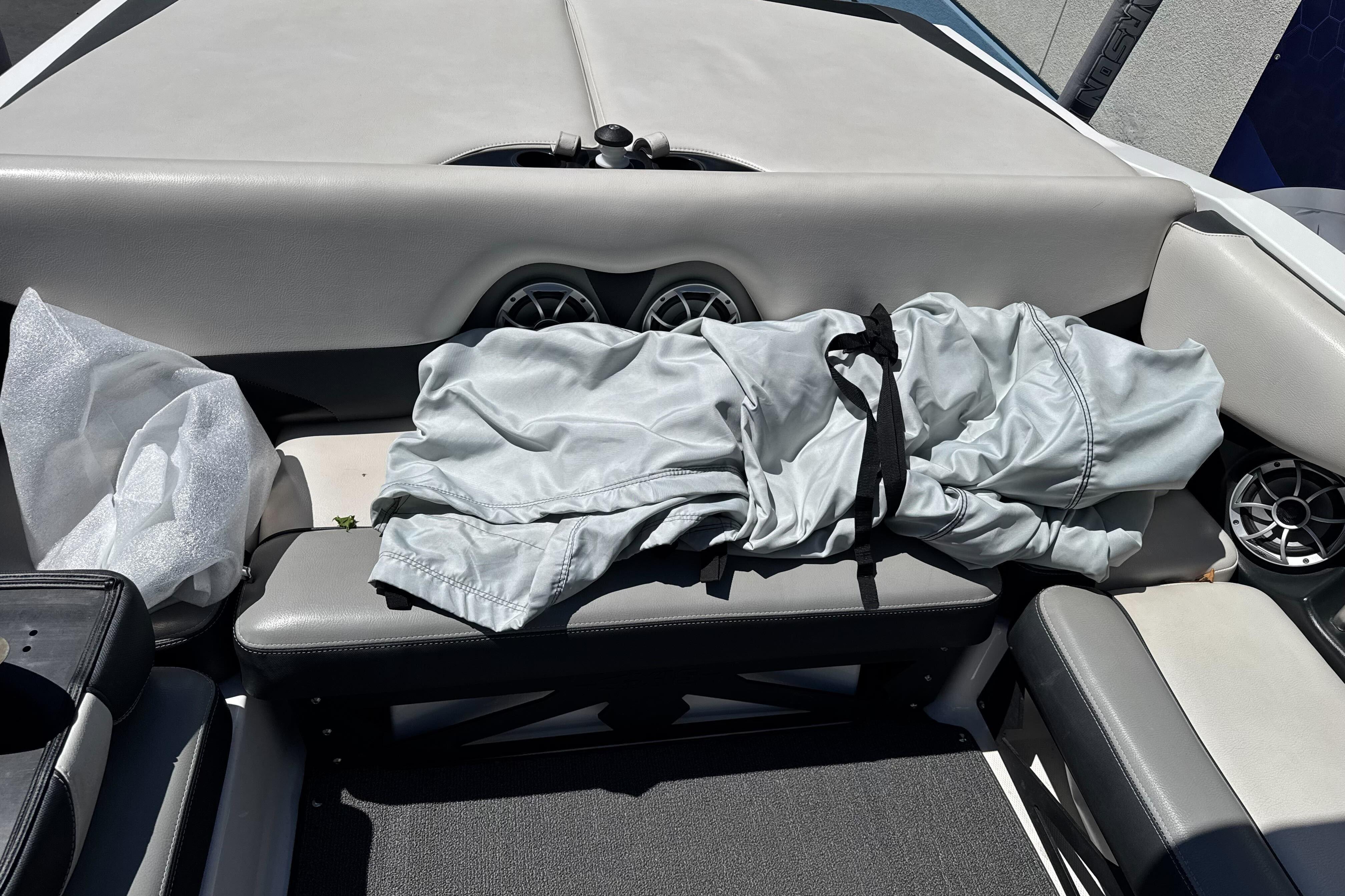 2015 Axis A20 boat interior with folded cover and speakers on seats.