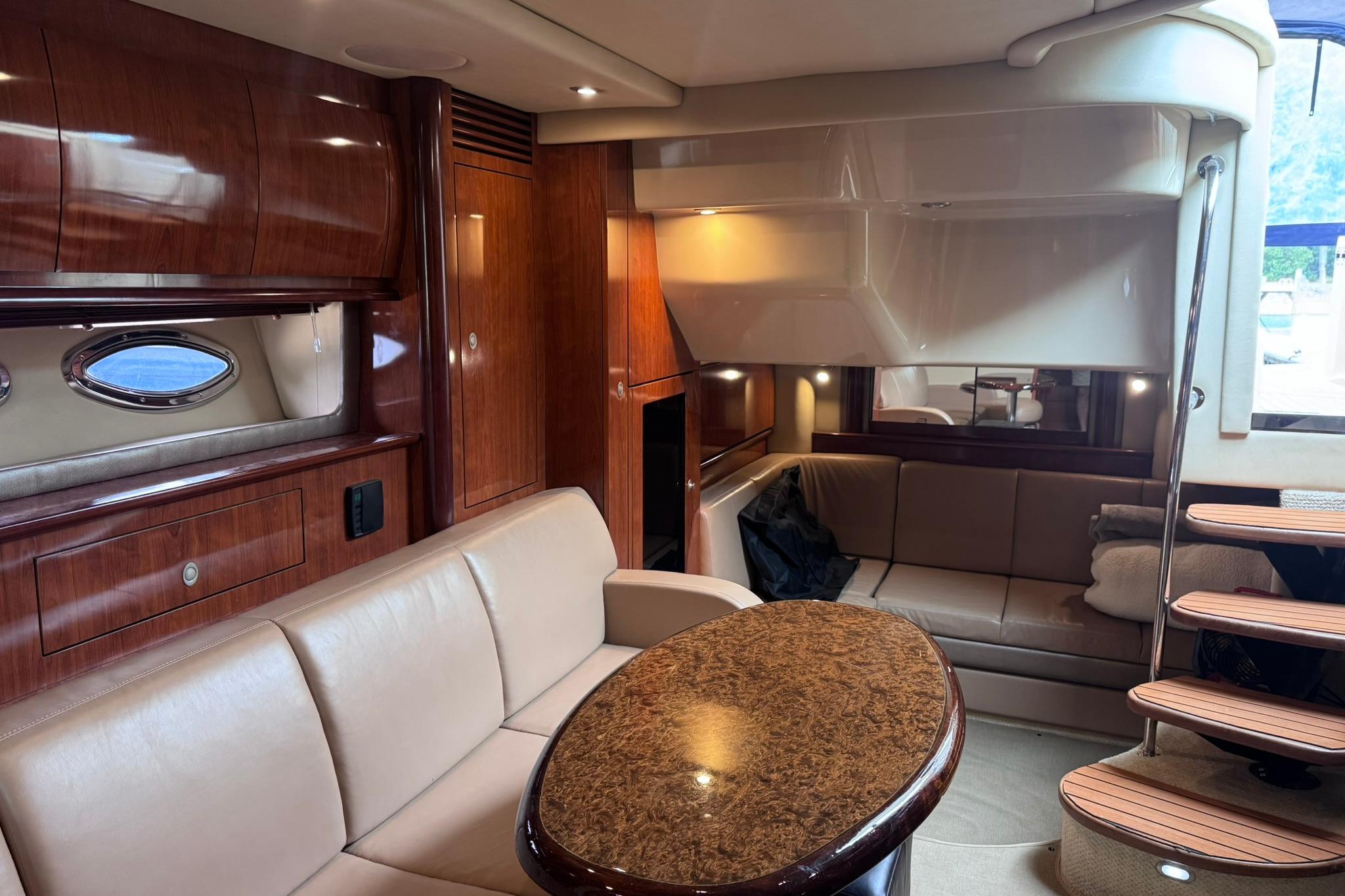 Luxurious interior of a 2004 Sea Ray 390 Sundancer yacht with elegant wood finishes.