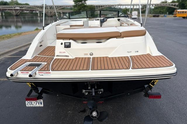 2017 Searay SPX210 boat with teak deck, parked near a waterfront.
