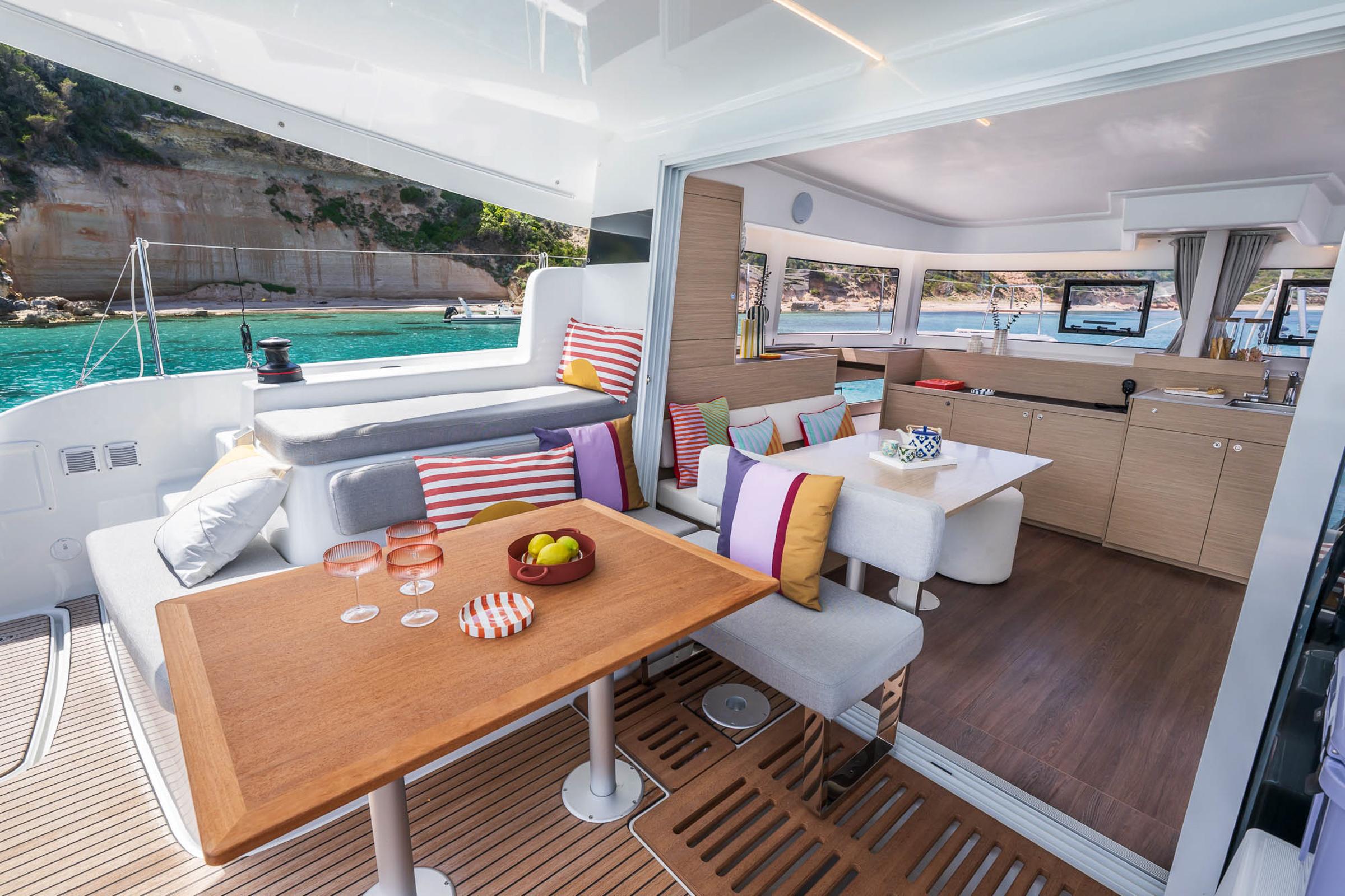 Luxurious Lagoon 38 catamaran interior, 2025 model, featuring elegant seating and scenic ocean views.
