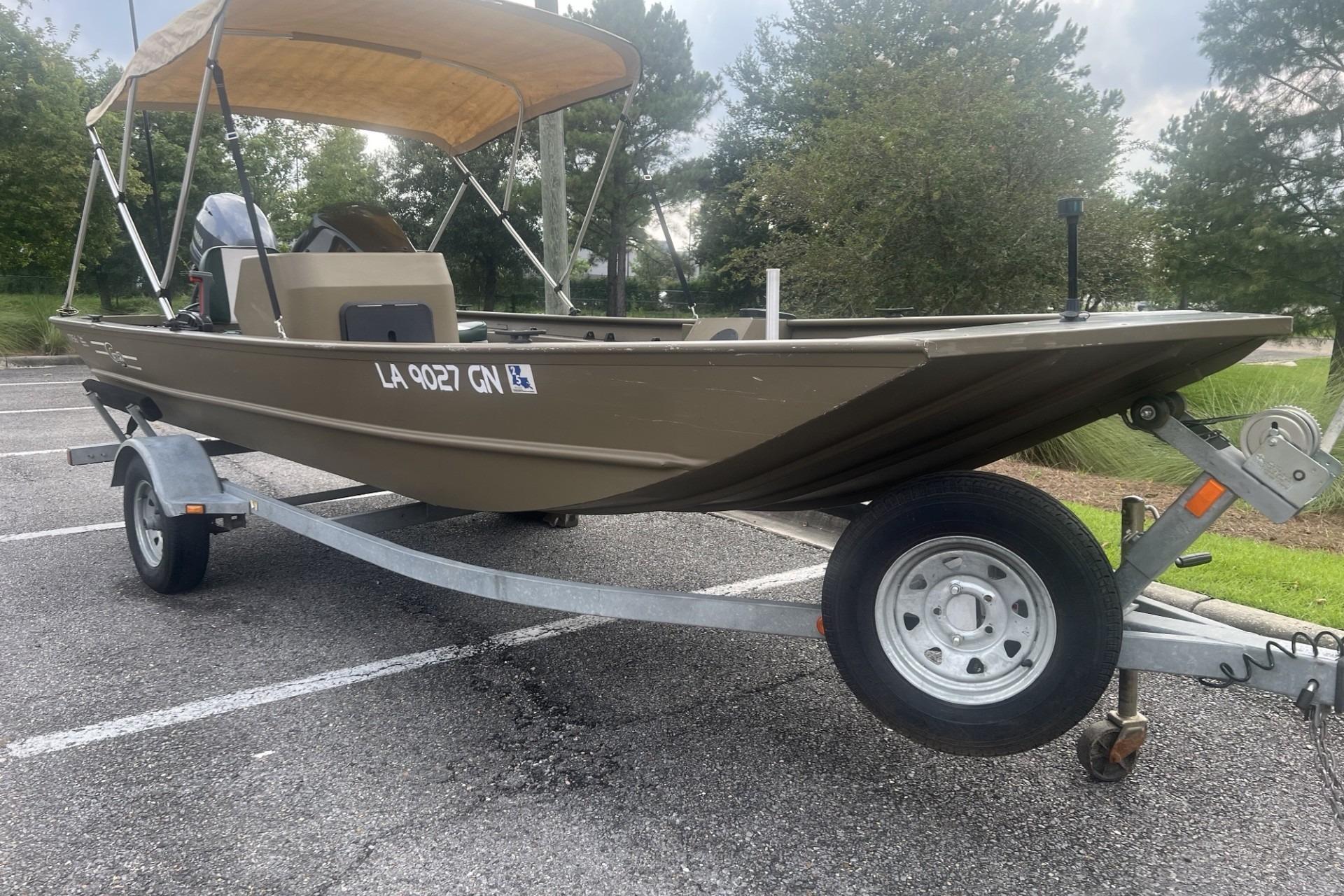 2016 G3 1756 SC boat on trailer with canopy in parking lot.
