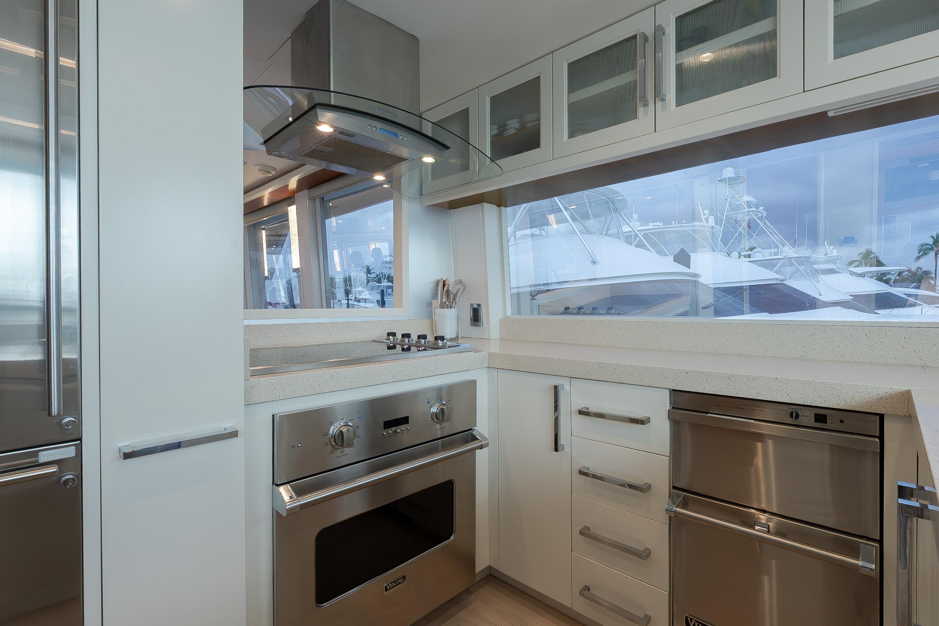 Modern kitchen interior on 2012 Lazzara Breeze yacht, featuring sleek appliances and large windows.