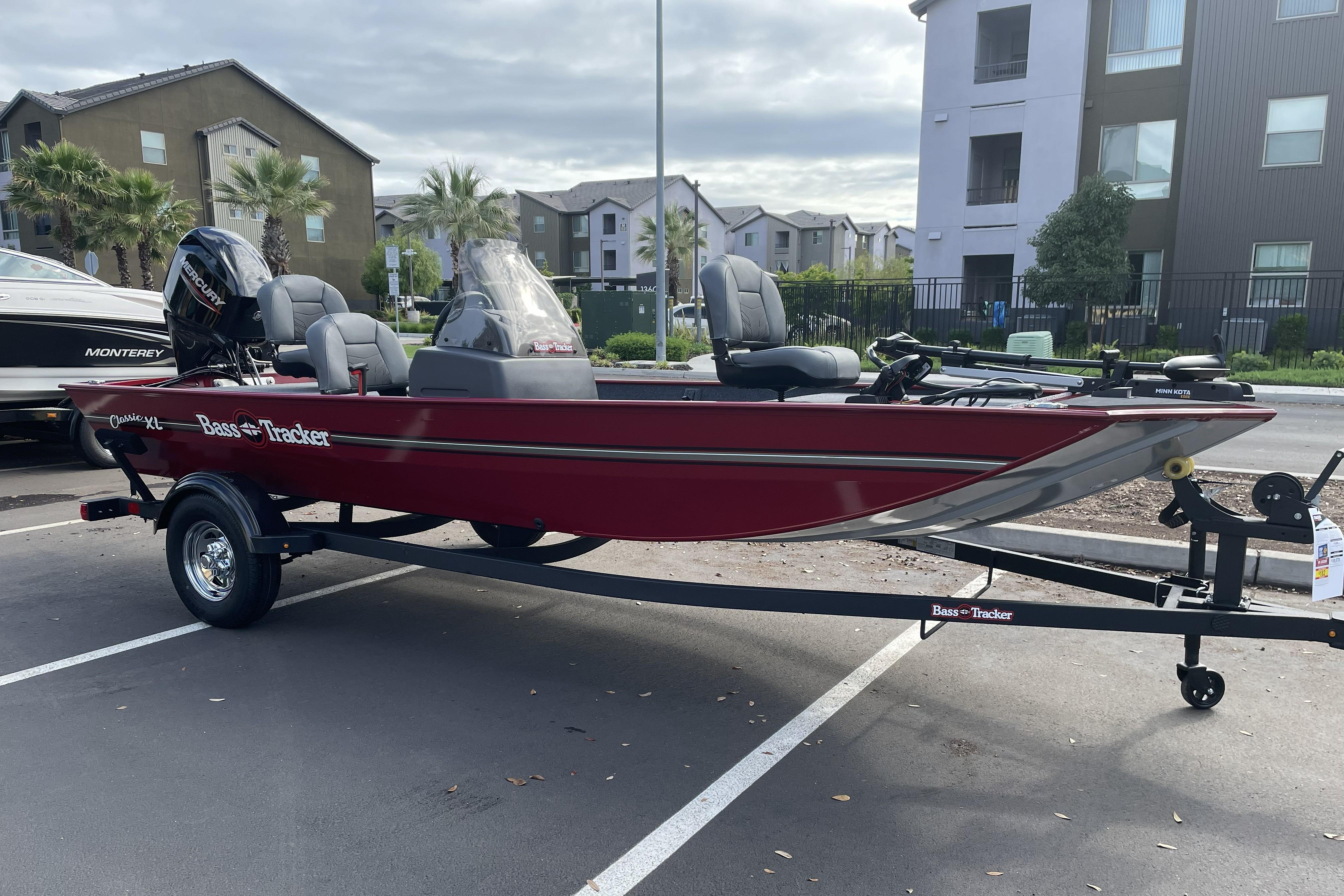2026 Tracker Bass Tracker Classic XL boat on trailer in parking lot.