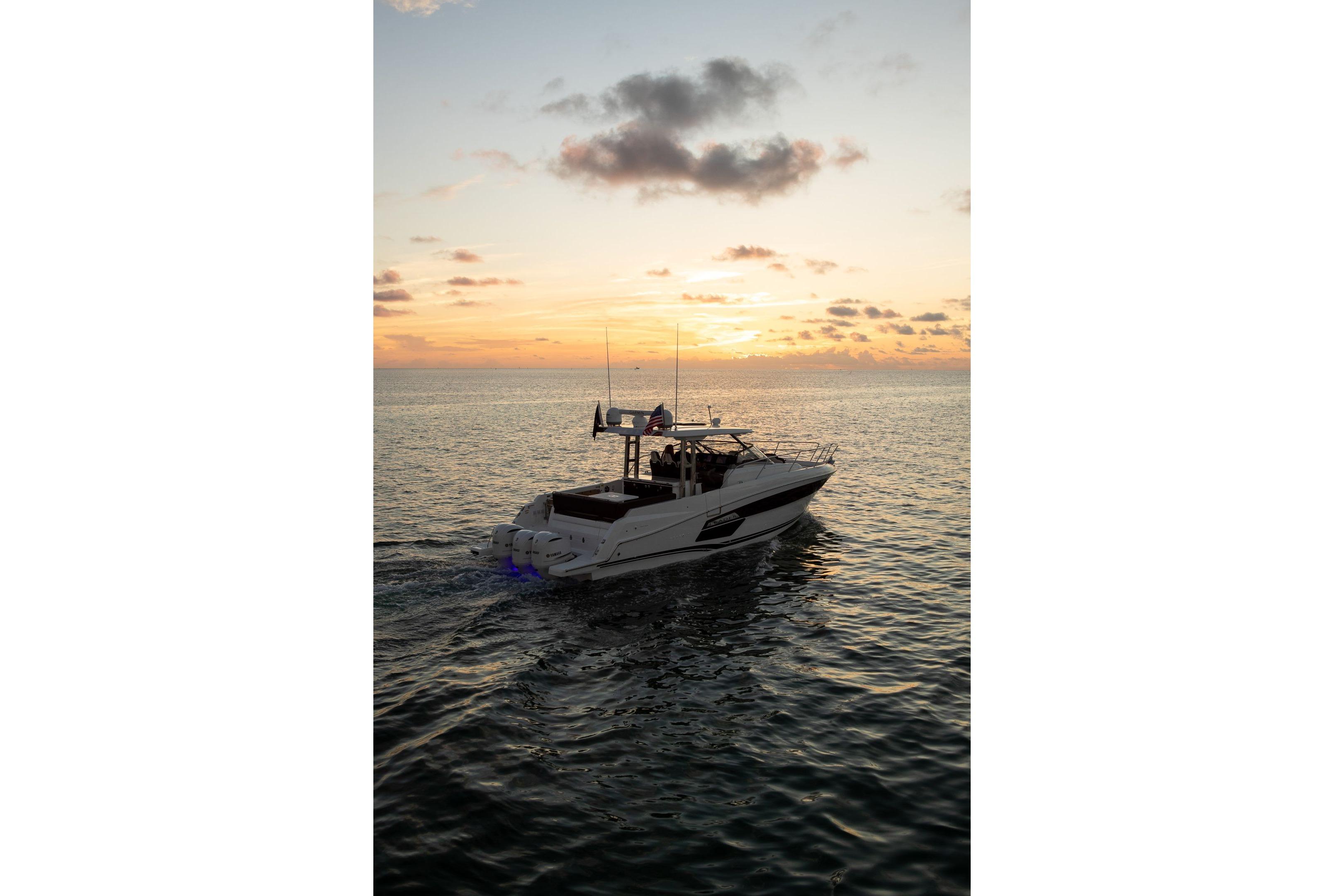 2026 Jeanneau Leader 12.5 WA cruising at sunset on calm ocean waters.