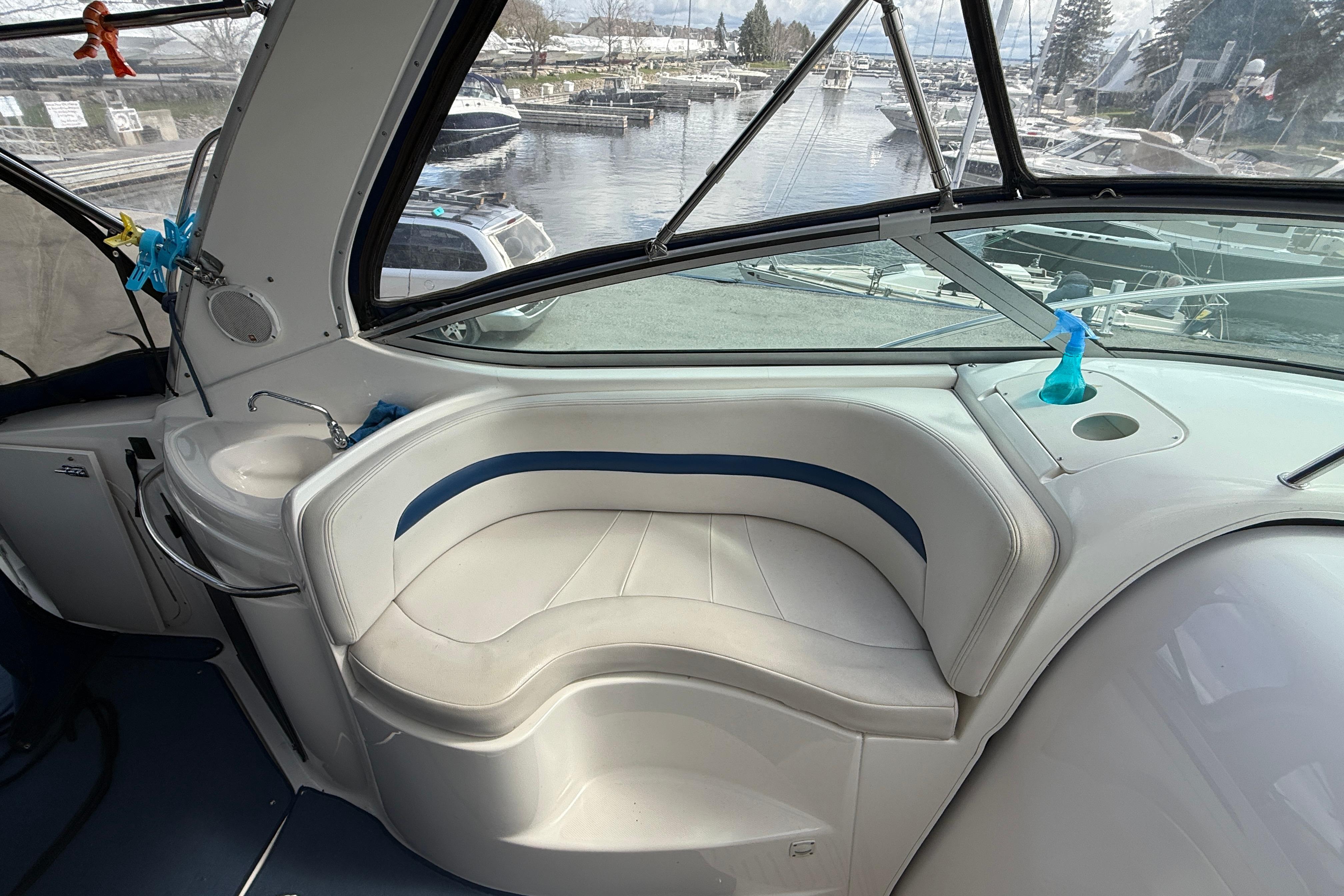 2003 Chaparral Signature 280 boat interior with white seating and marina view.